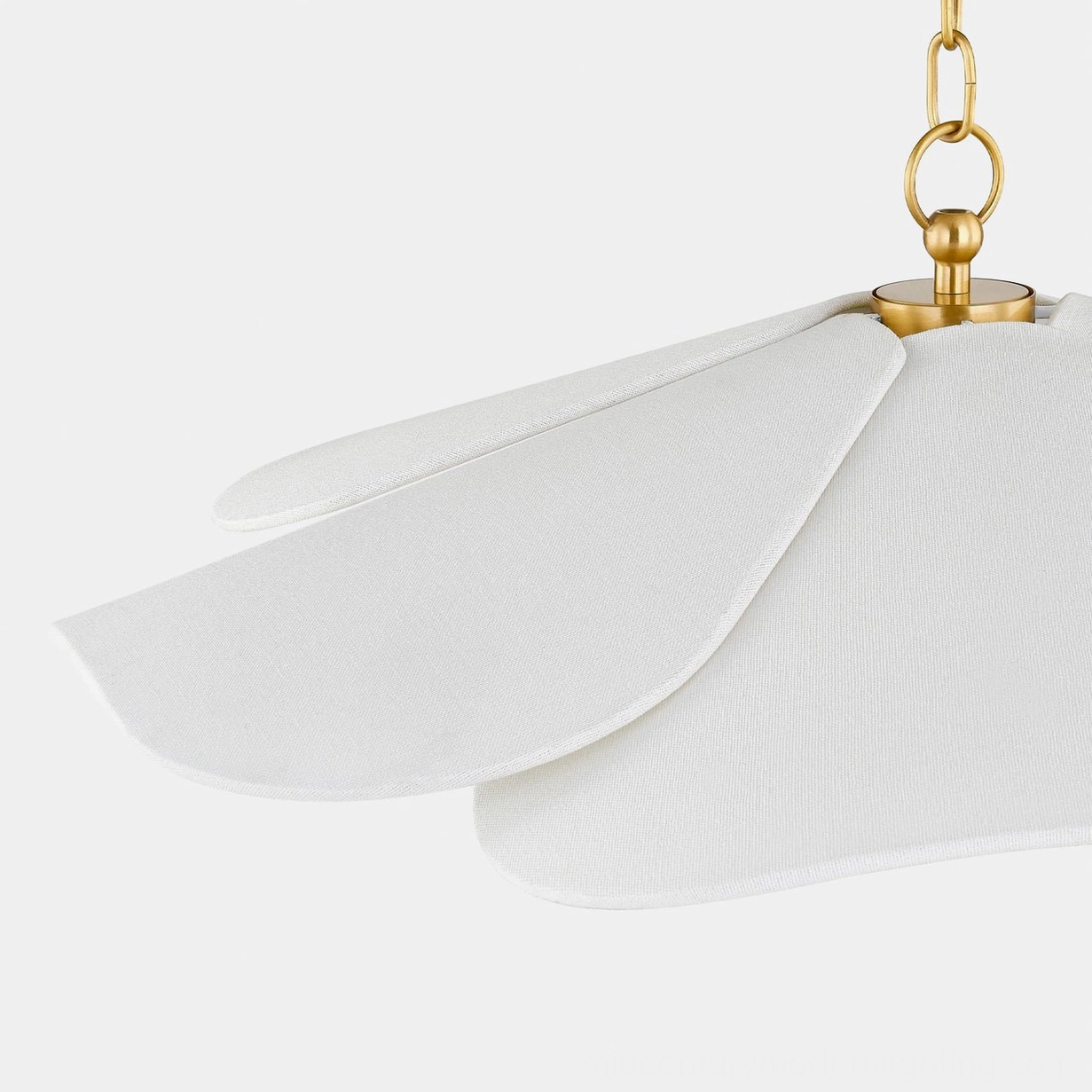 Ressi pendant light shade close-up detail, layered white fabric petals and polished brass hardware, studio background