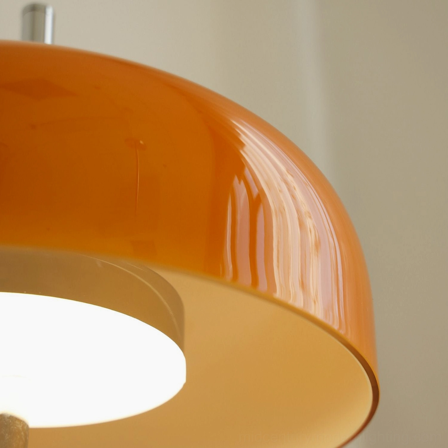 Retro 1990s-inspired orange table lamp styled in contemporary mid-century modern interior space