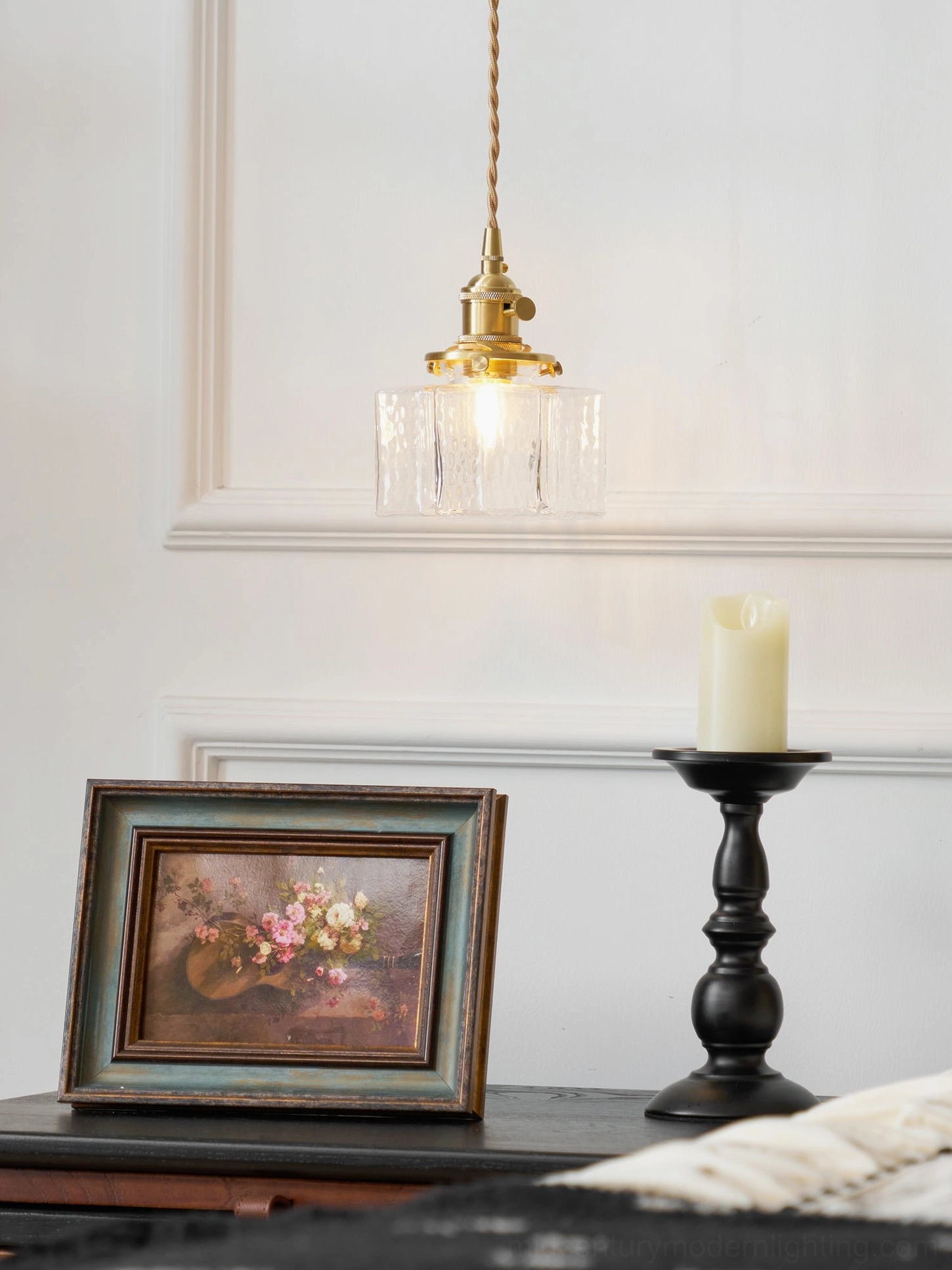 Retro brass hanging wall lamp with cylindrical rippled glass shade and framed art wall display