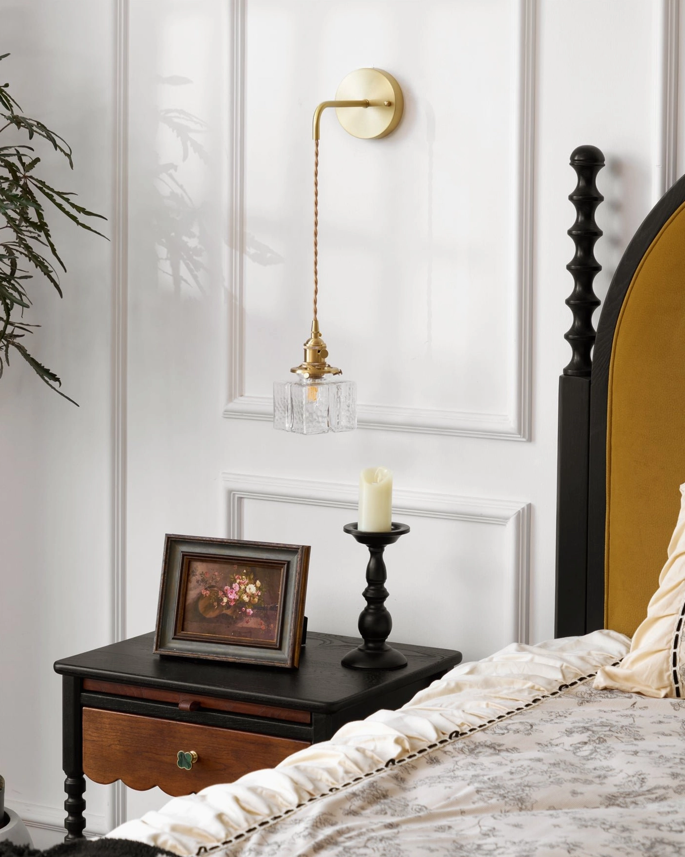 Classic retro brass wall lamp with small rippled glass shade in vintage bedroom nightstand display