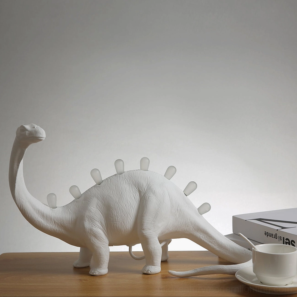 Multiple dinosaur table lamps arranged, Rex and Bronto models comparison