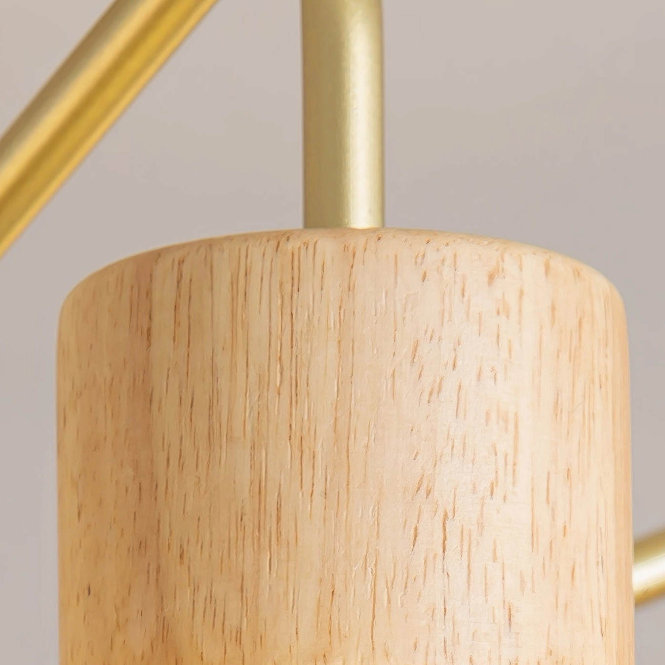 Modern ribbed glass chandelier showing gold finish frame with wooden base cap detail