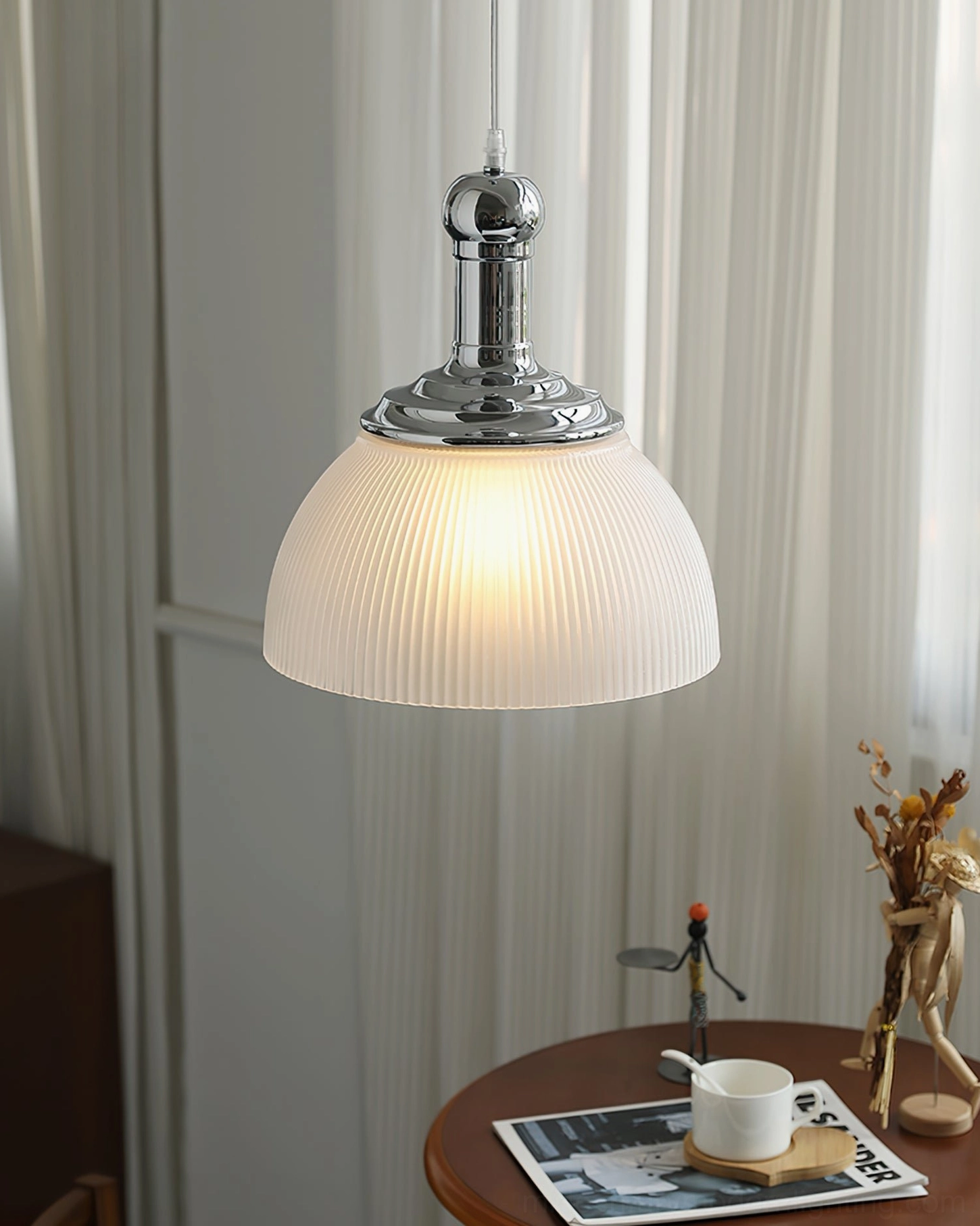 Ribbed chrome pendant light artistic composition highlighting glass texture and light diffusion quality
