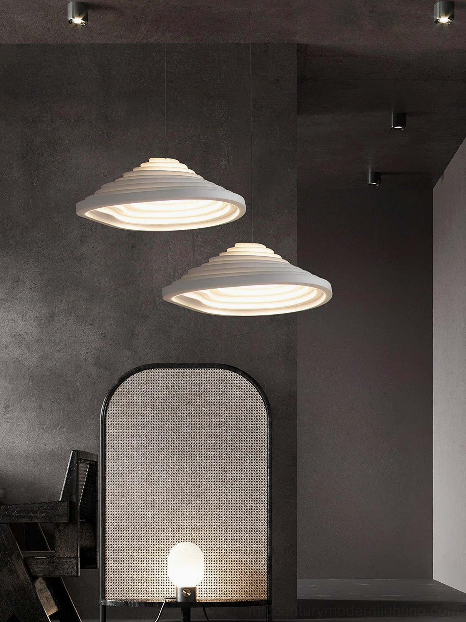 Two Rice Field acoustic tapered pendant lights creating ambient glow in dark-toned minimalist lounge space