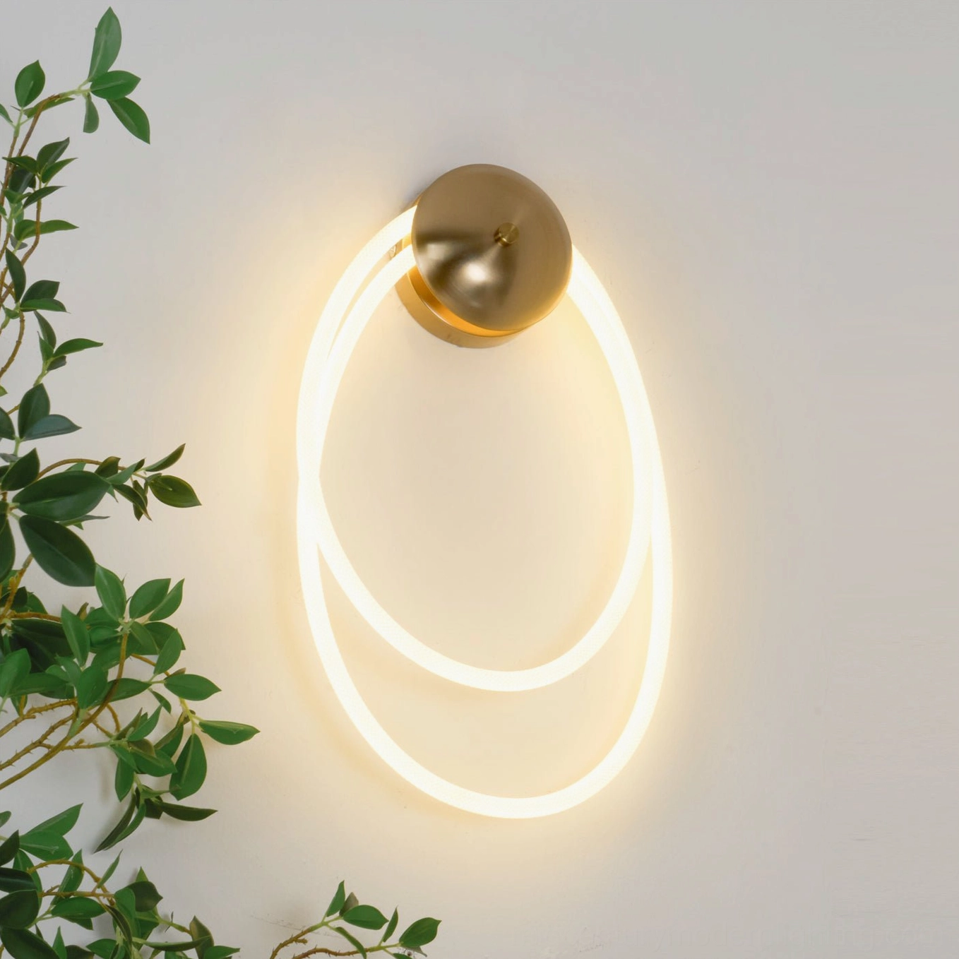 Rigel sculptural wall lamp with nested oval light strips left-side view with foliage backdrop