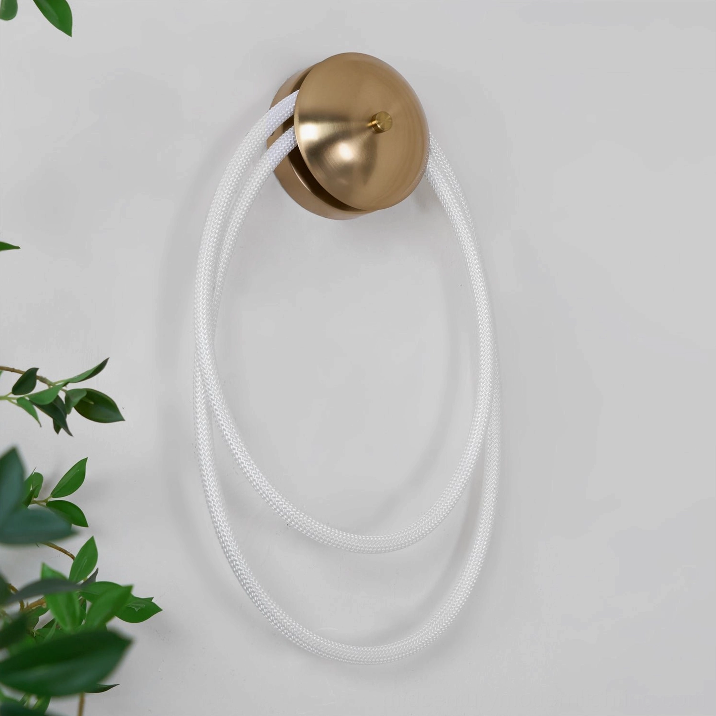 Rigel sculptural wall lamp right-side view with matte white rope and brass gold mount