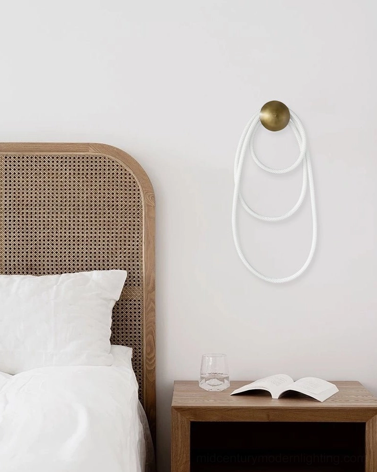 Rigel modern wall lamp illuminated showing warm diffused light through woven silicone fiber