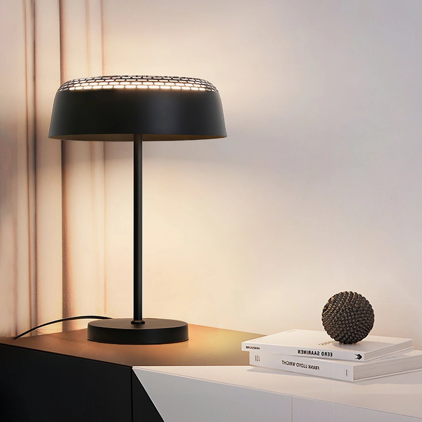 Ring T1 black LED table lamp with stacked books and geometric decor on side table display