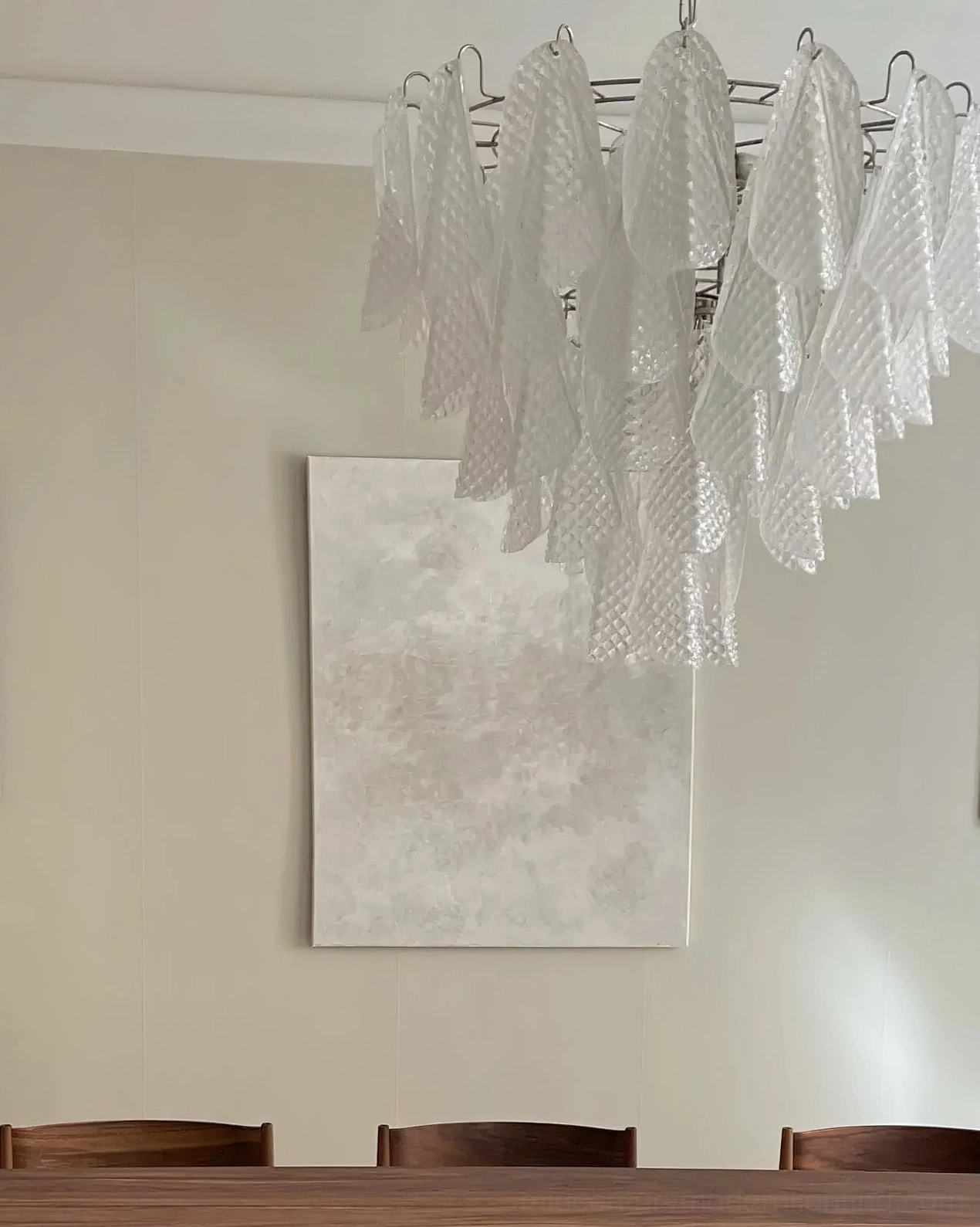 Ripple glass chandelier three-quarter view showing glass petal formation and hanging chain attachment