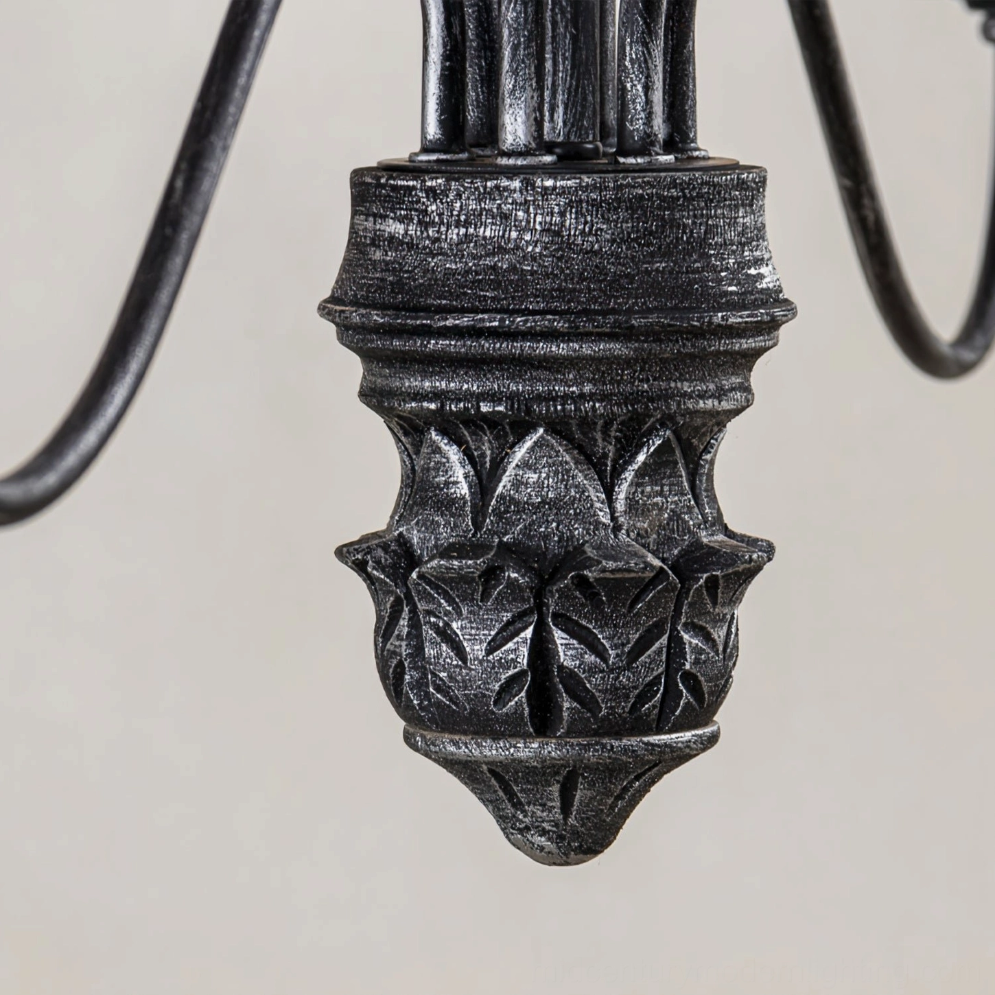 Rohan chandelier ornamental central base close-up showing carved leaf pattern and distressed black metal finish detail