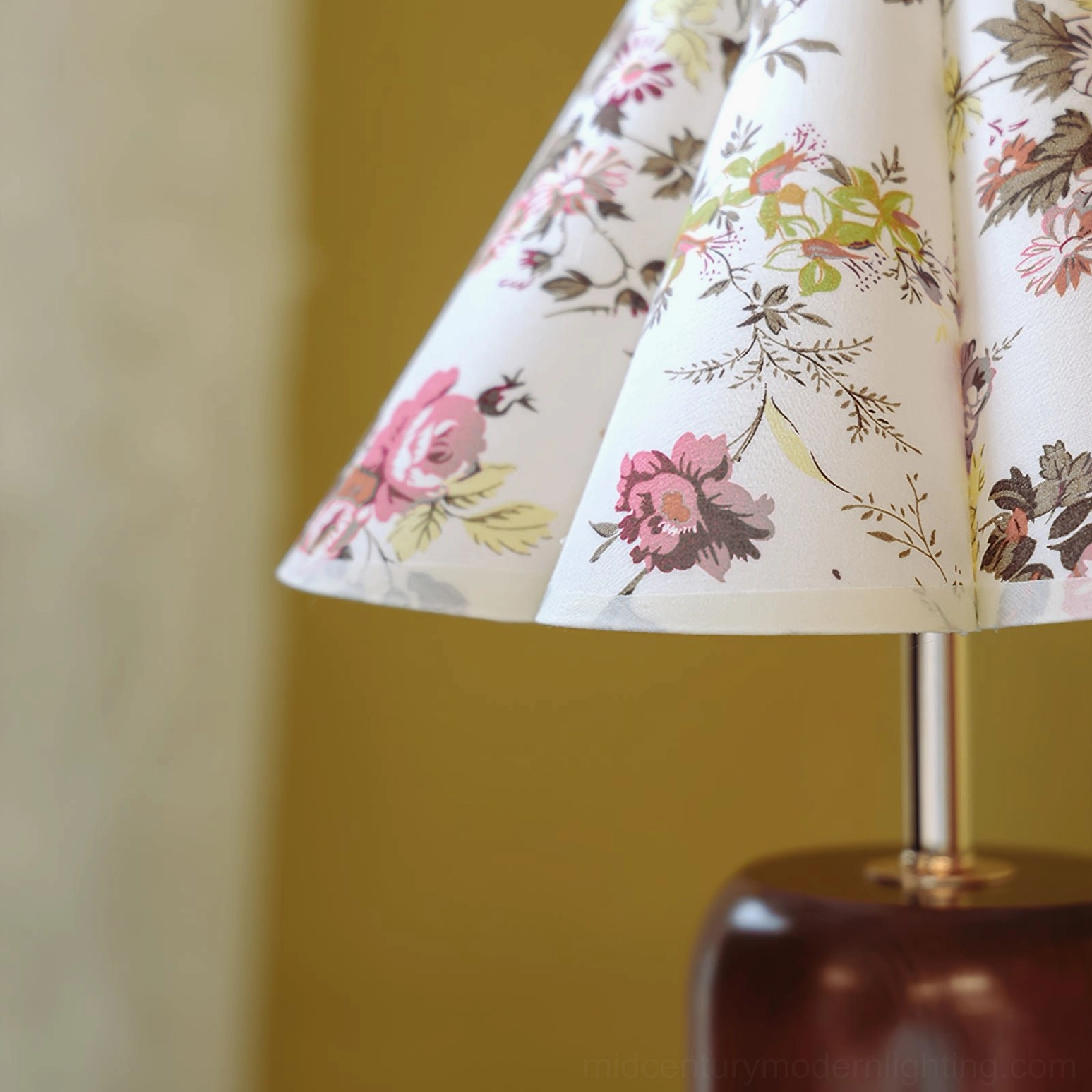 Pleated lampshade close-up showing fabric texture and botanical green leaf details