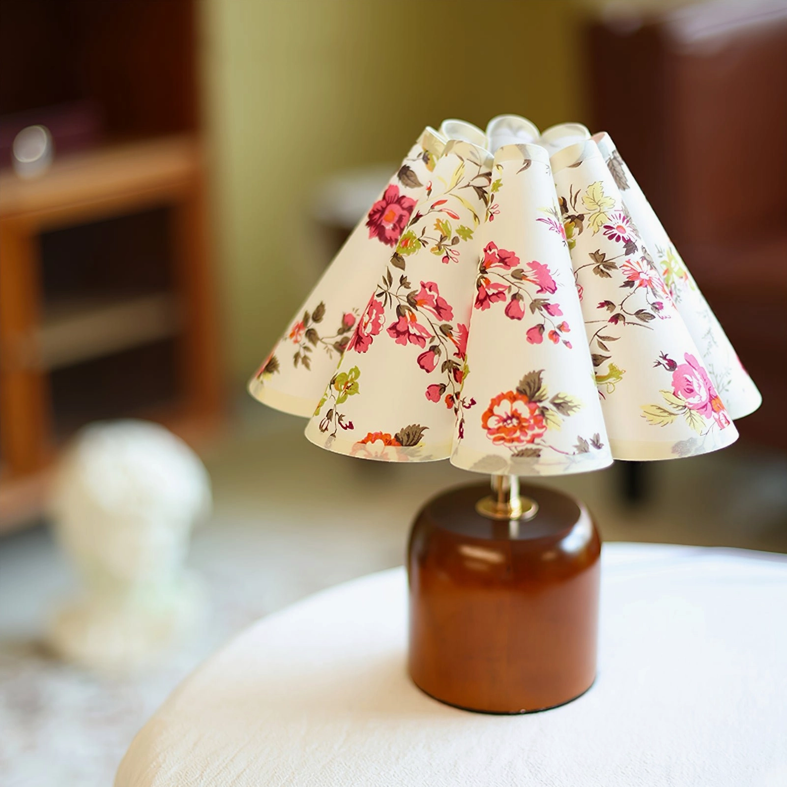 Compact wooden lamp base with pink floral pattern shade, three-quarter indoor view