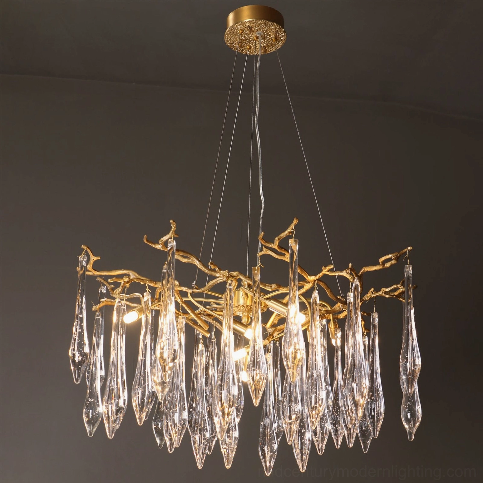 Round branch crystal chandelier overhead full view suspended by multiple brass wires on ceiling