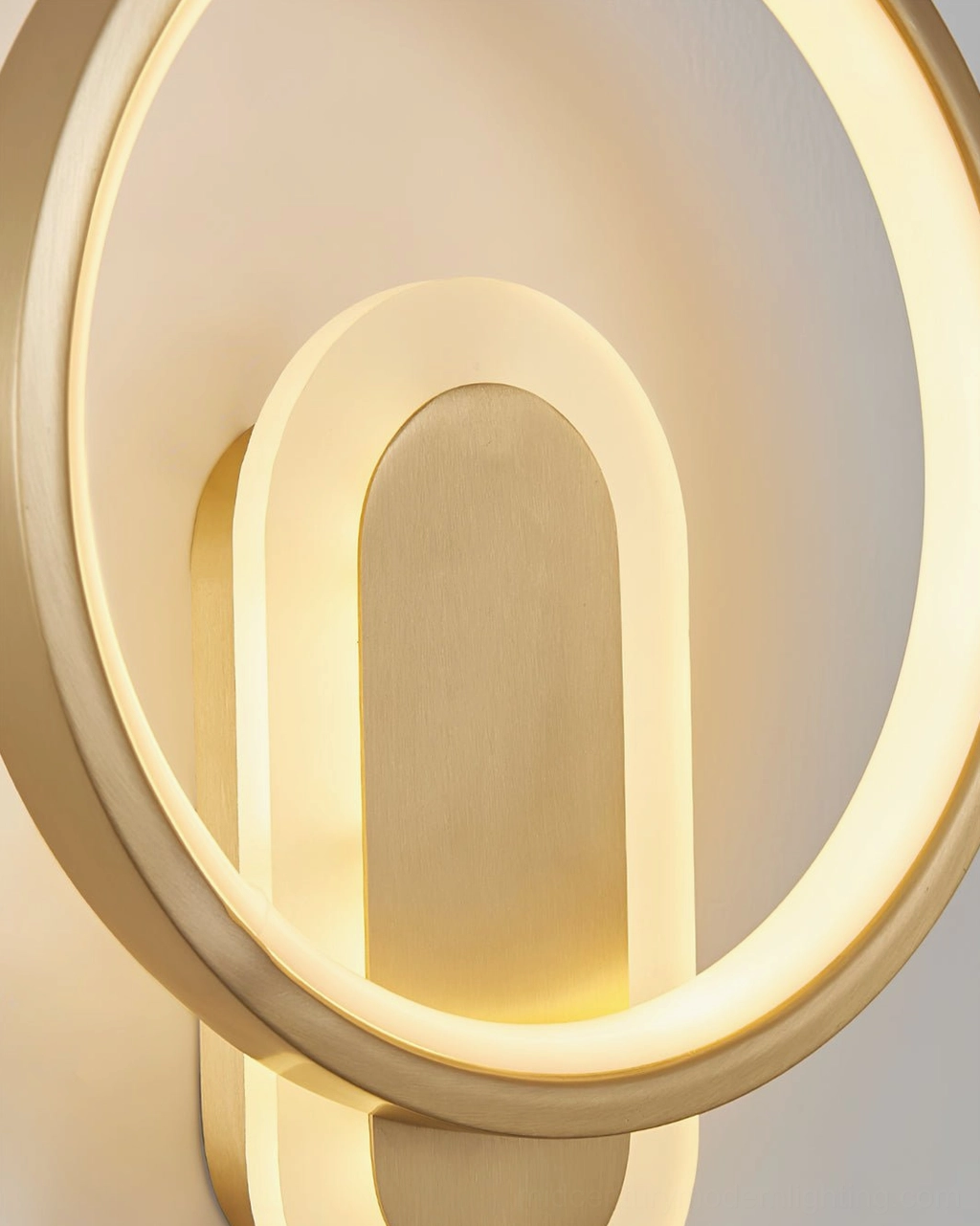Minimalist round wall lamp close-up of circular brass frame and LED light emission