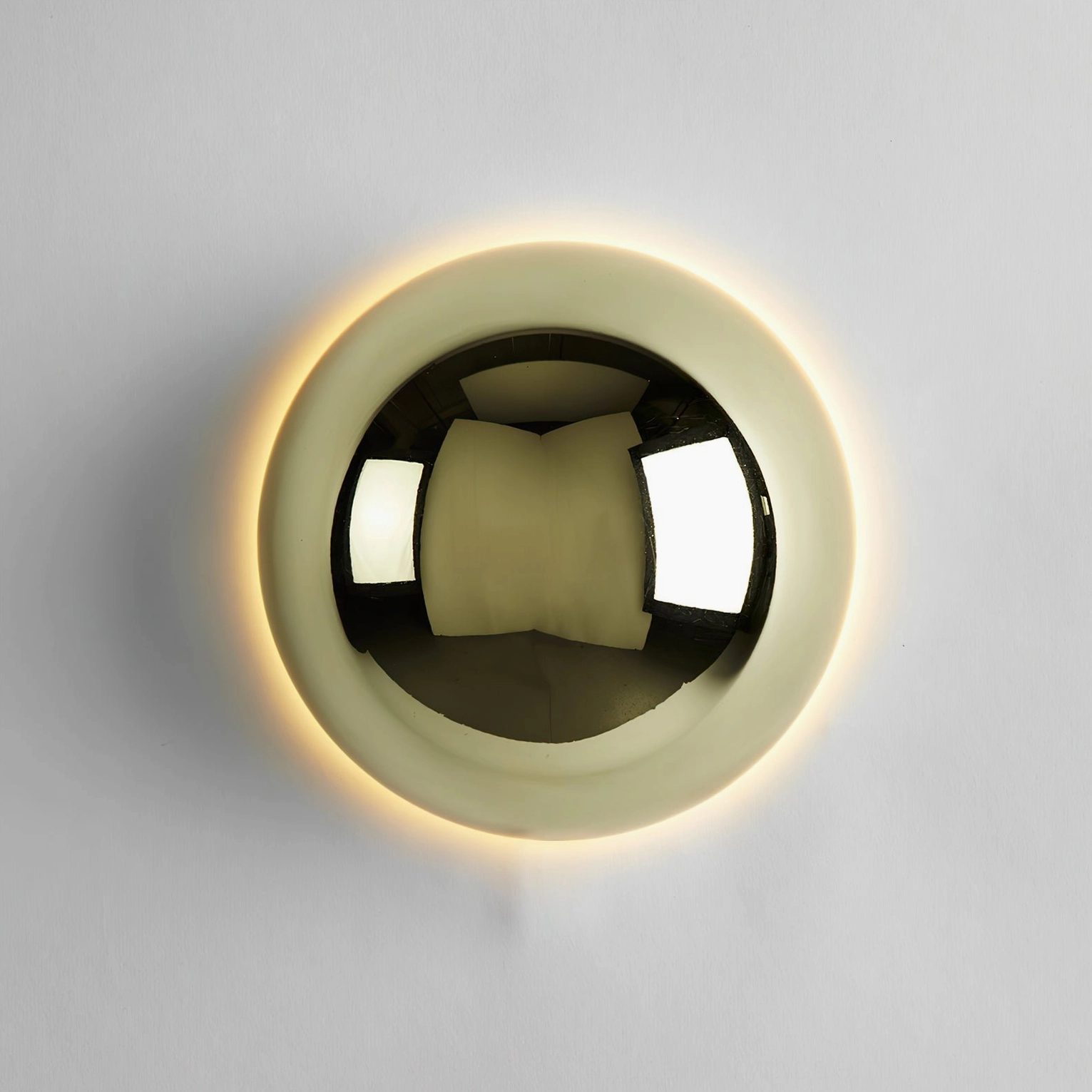 Minimalist round metal wall lamp demonstrating cool white light emission