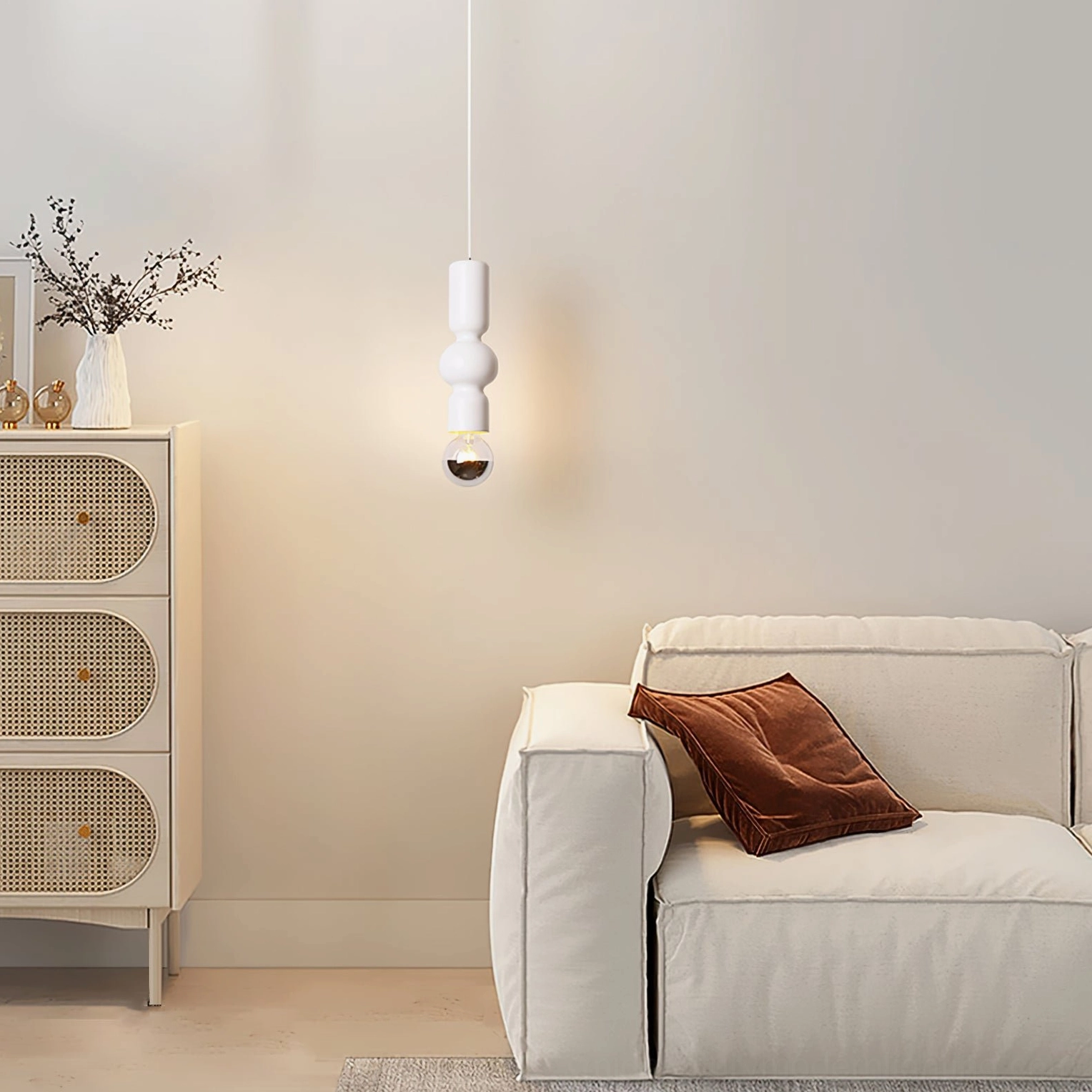 Rudd matte white stacked cylinder pendant light with exposed vintage bulb in contemporary living room with linen sofa