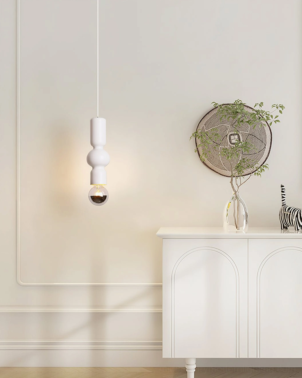 Rudd white cylindrical pendant light hanging in neoclassical entryway with white cabinet and decorative accents