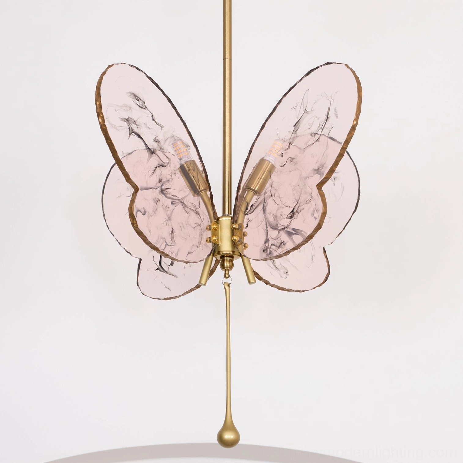 Unlit pink marbled butterfly pendant lamp showing translucent glass wing detail in studio setting