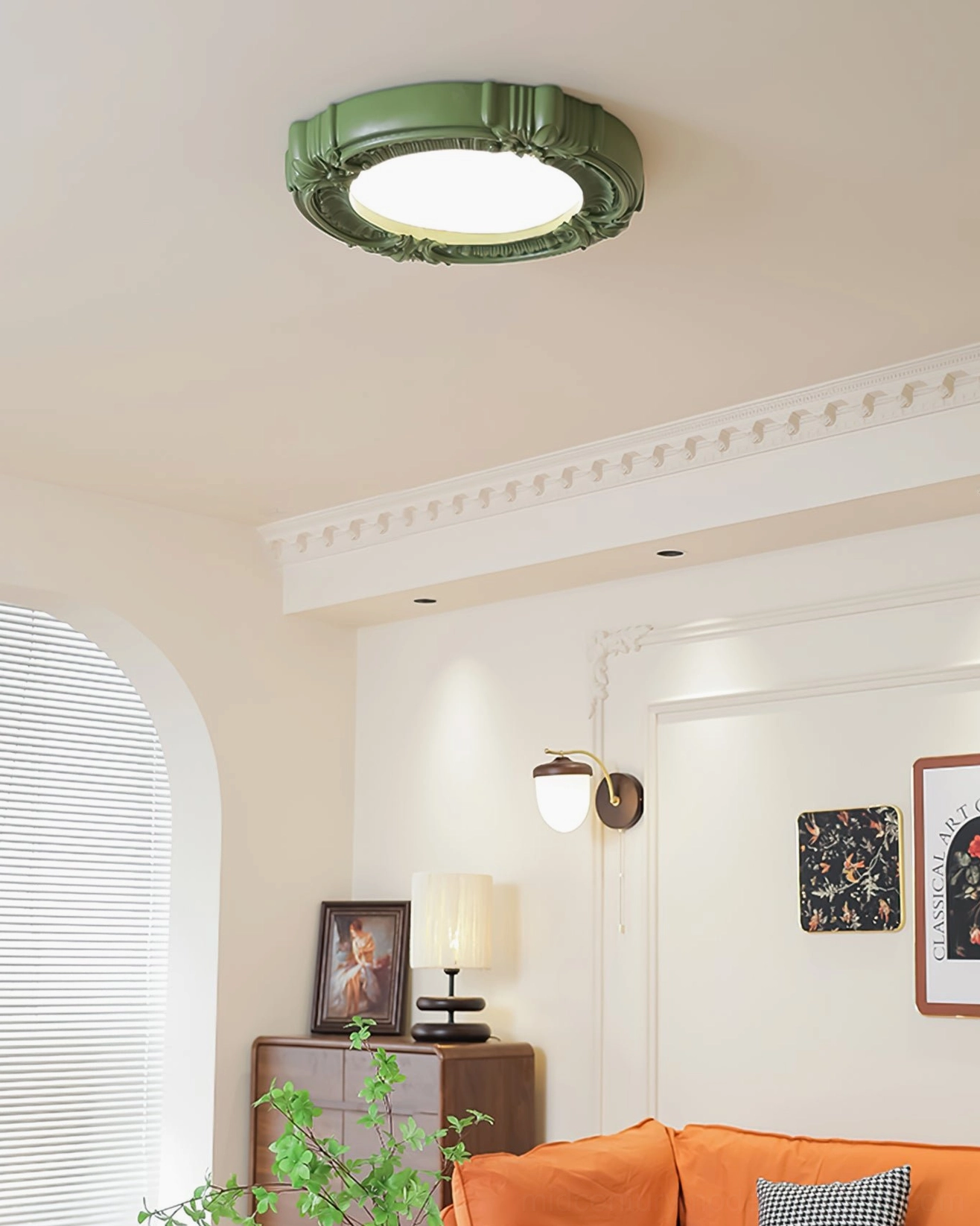 Sage green ornate ceiling lamp with detailed floral carvings installed above vintage living room sofa