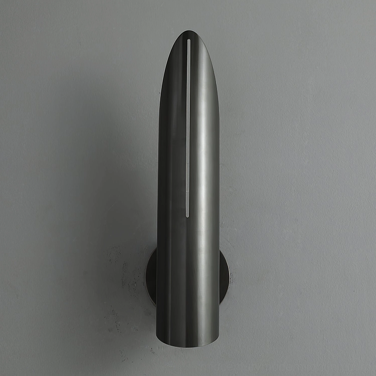 Single Salvatore matte black bullet wall sconce sleek modern cylindrical design side view on textured wall