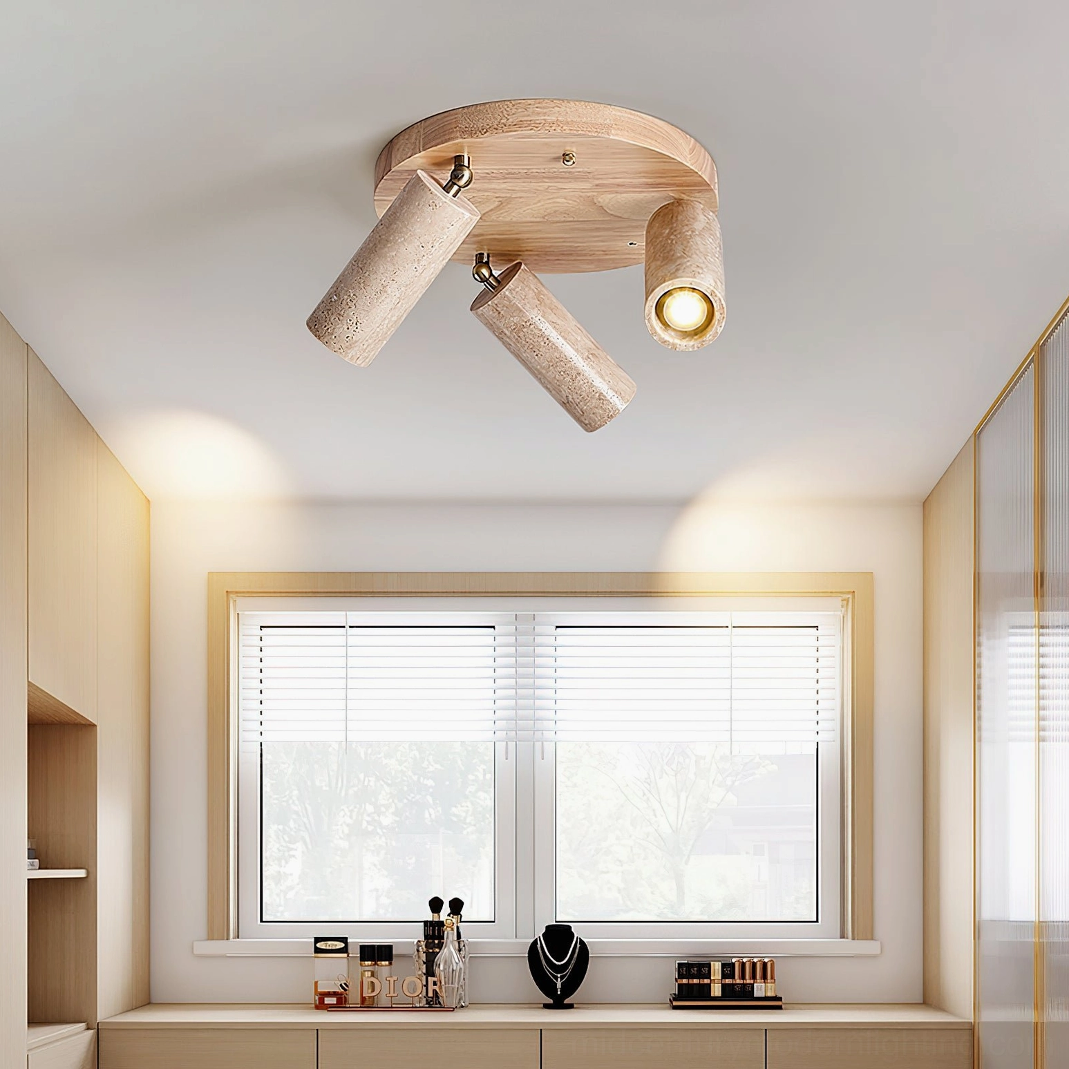 Sandia adjustable ceiling spotlight with light wood base and beige travertine heads above vanity counter area