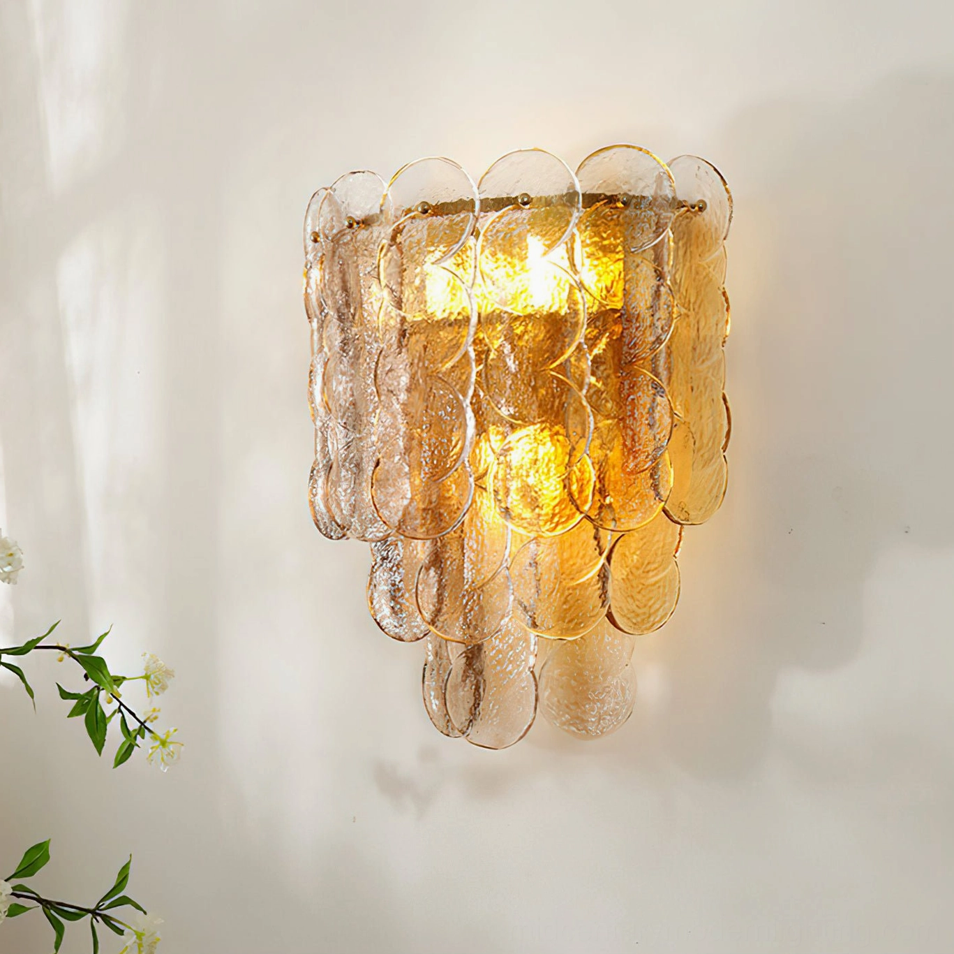 Scalloped edge glass wall sconce three-quarter view showing segmented amber glass design