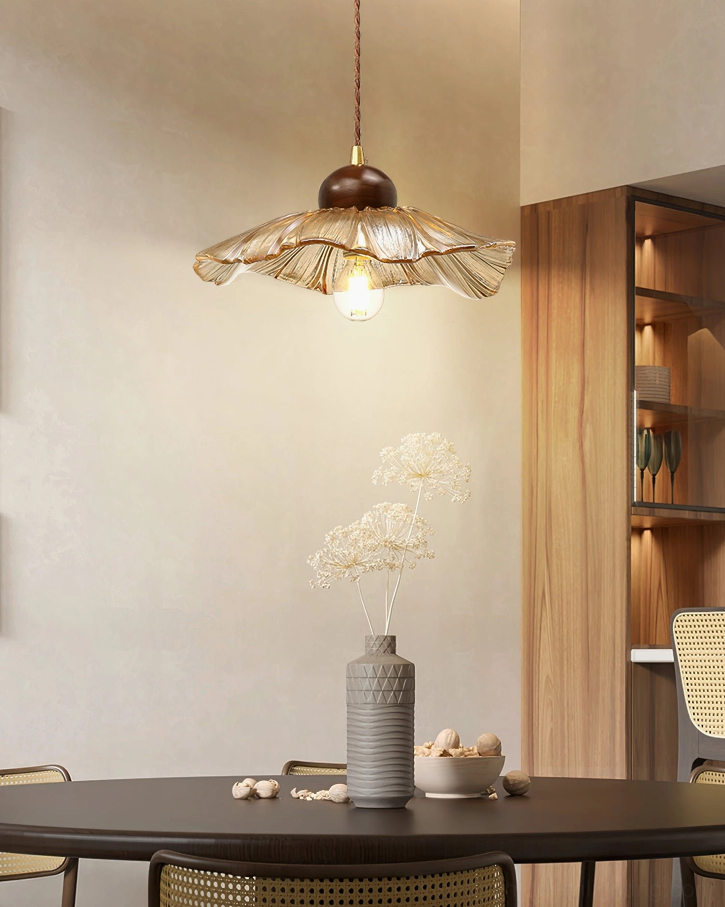 Scalloped pendant lamp in formal dining area above minimalist table setup