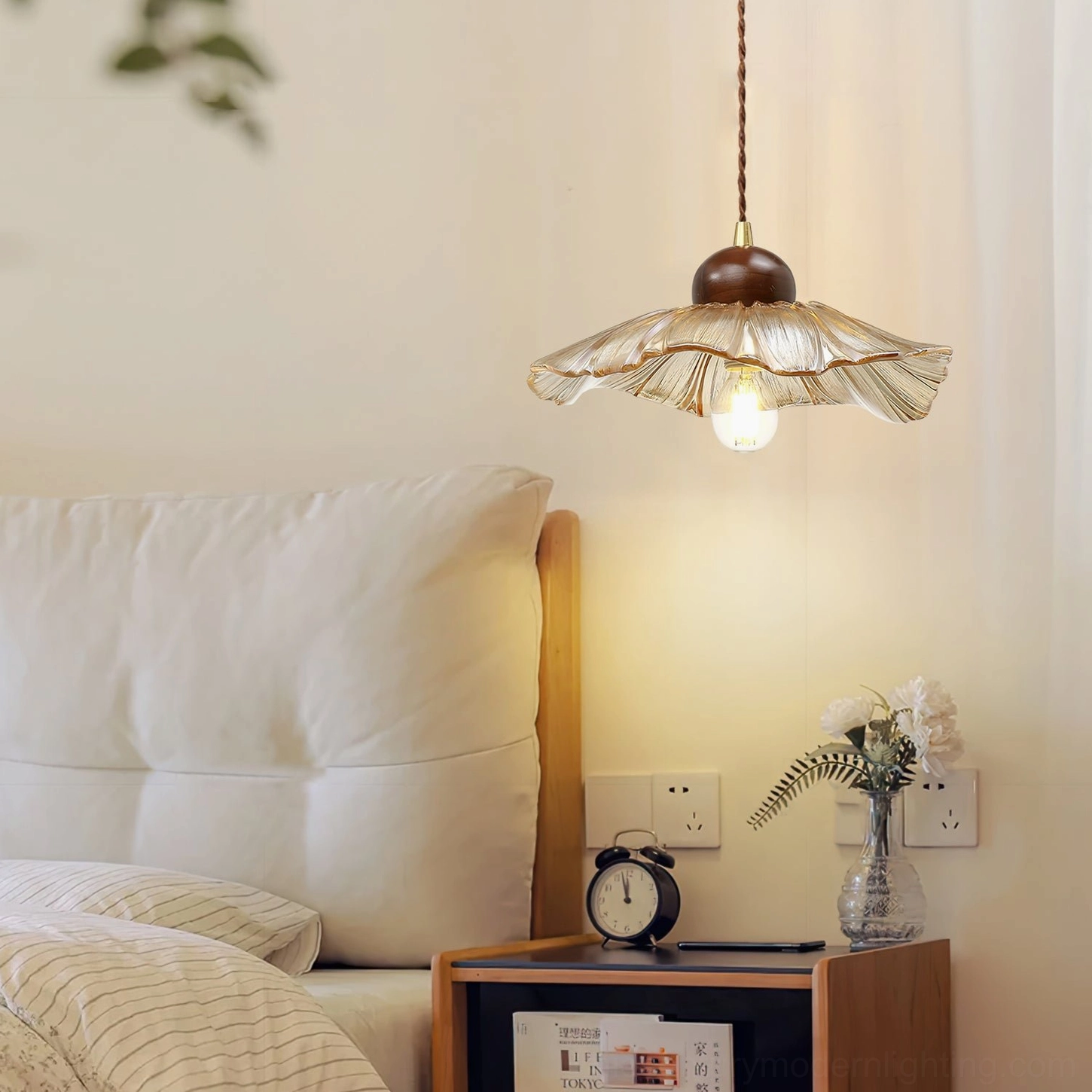 Scalloped pendant lamp hanging in warm vintage bedroom bedside setting