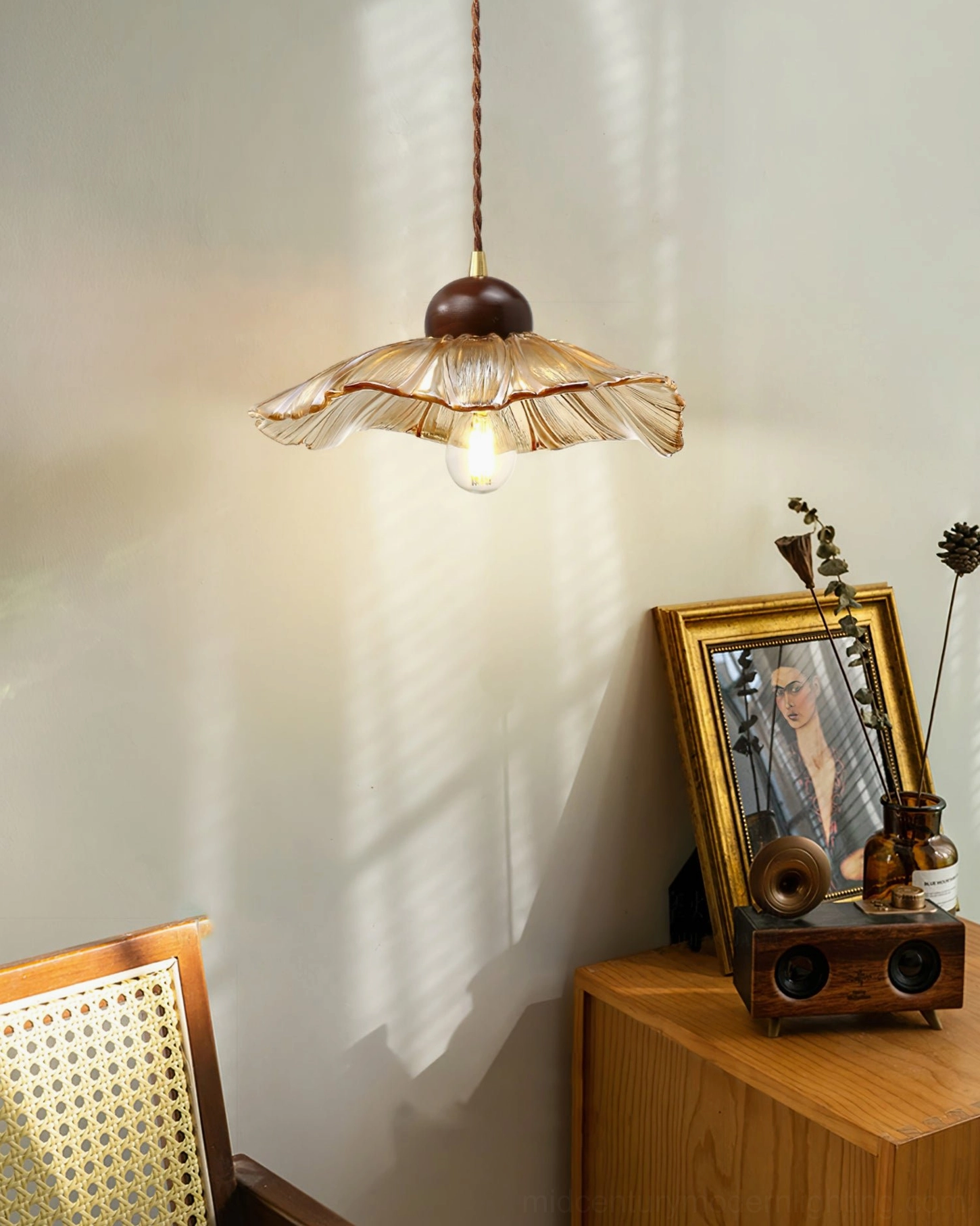Scalloped pendant lamp paired with retro decorative table ornaments vintage corner
