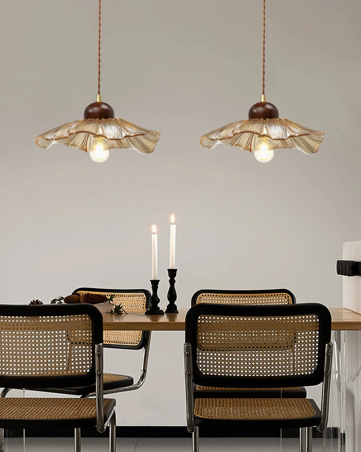 Dual scalloped pendant lamps hanging in cozy rustic dining room warm atmosphere