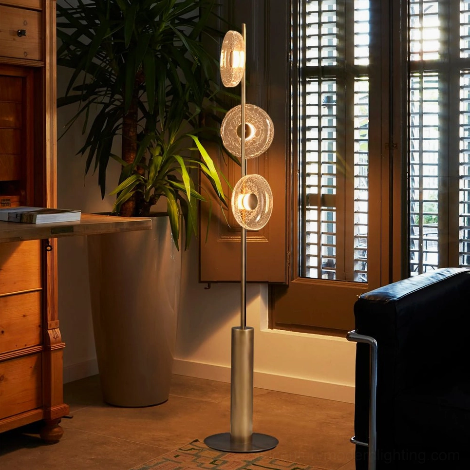 Modern floor lamp with multi-tiered crackle glass design demonstrating sculptural architectural presence