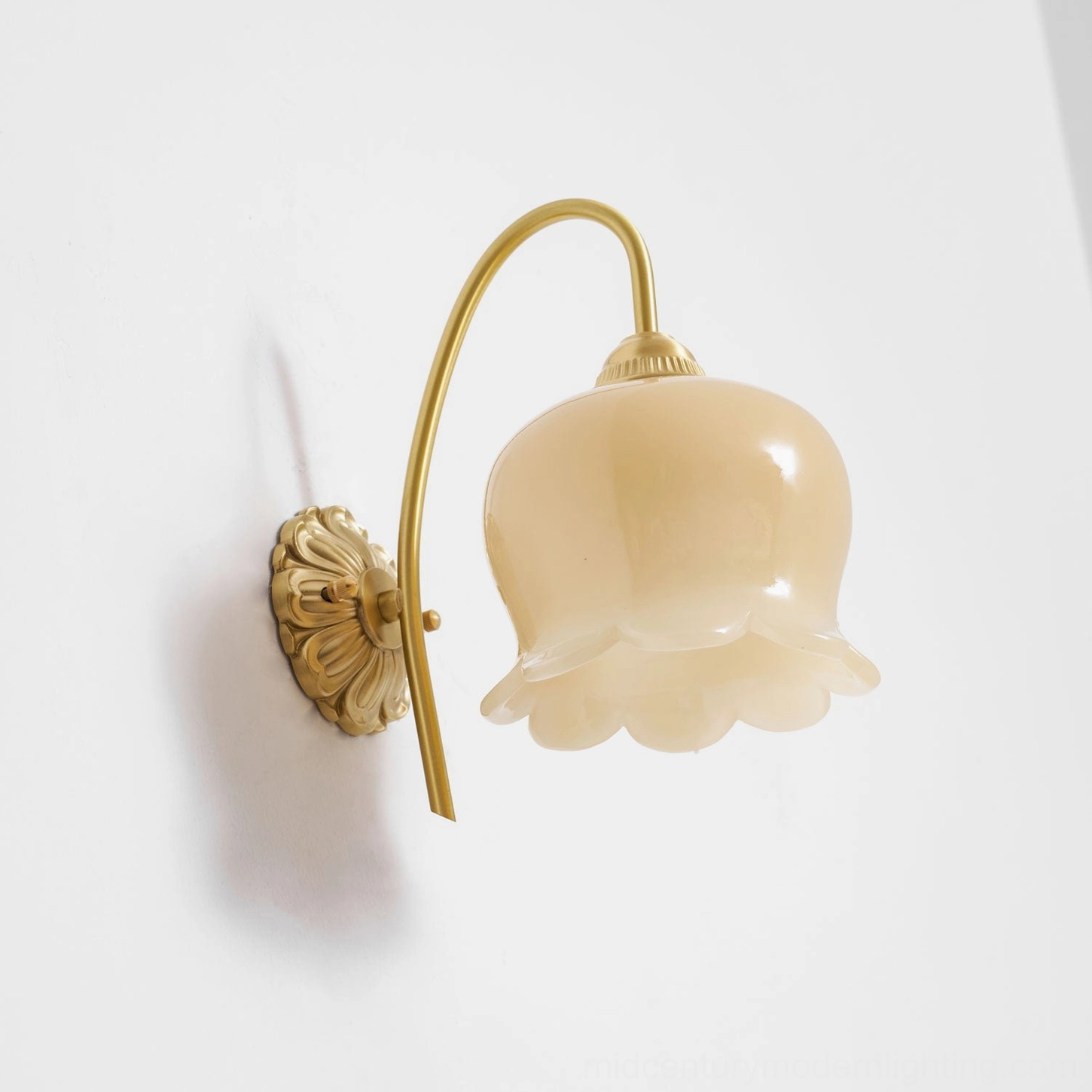 Sculptural detail view of lily of the valley wall lamp showing hand-crafted glass petals