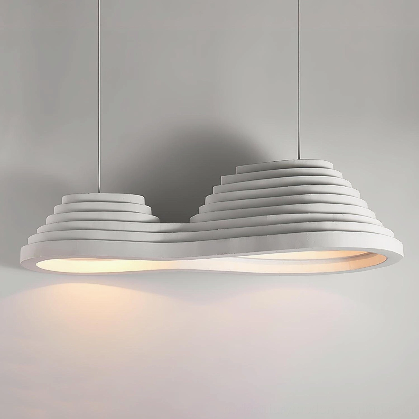 Clean minimalist view of tiered pendant light structure on neutral gray background highlighting layered silhouette