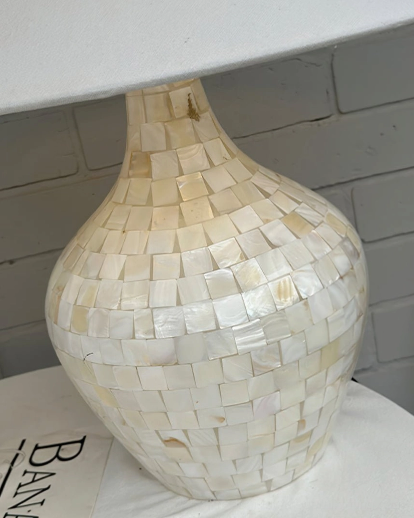 Handcrafted seashell mosaic table lamp detail showing natural shell inlay base and fabric shade craftsmanship