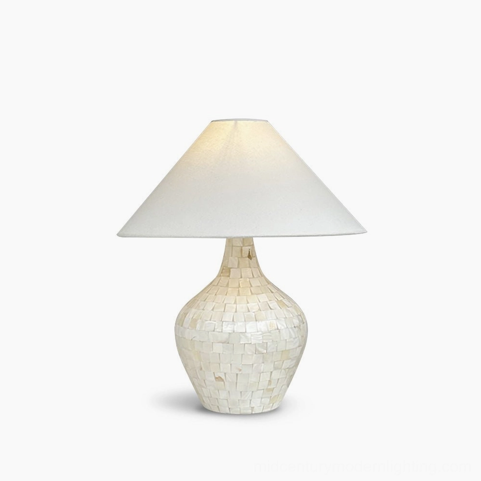Seashell mosaic table lamp with creamy white fabric shade and handcrafted shell inlay base, studio lighting on white background