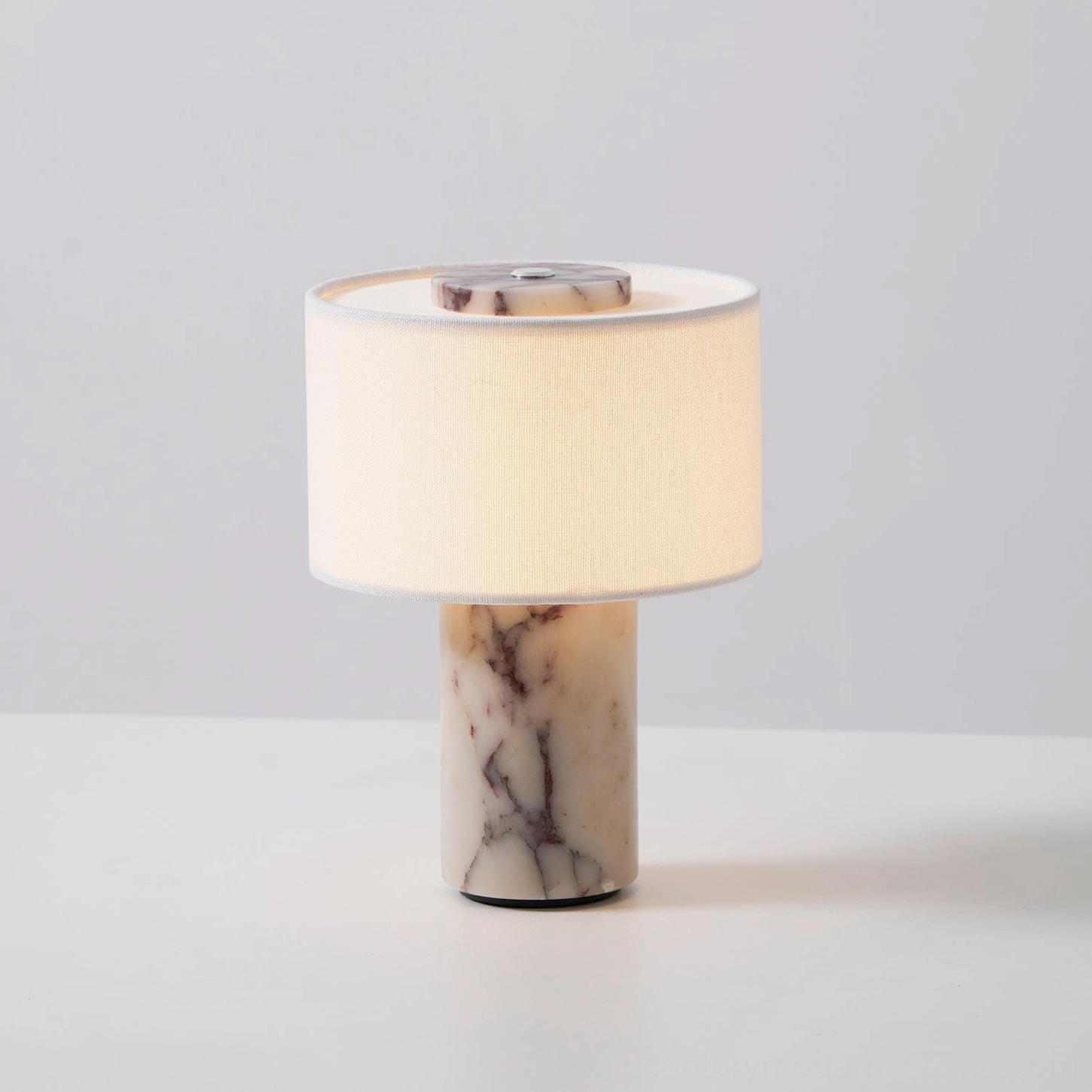 Beige marble cylindrical base with brown veining detail on Sediment cordless table lamp