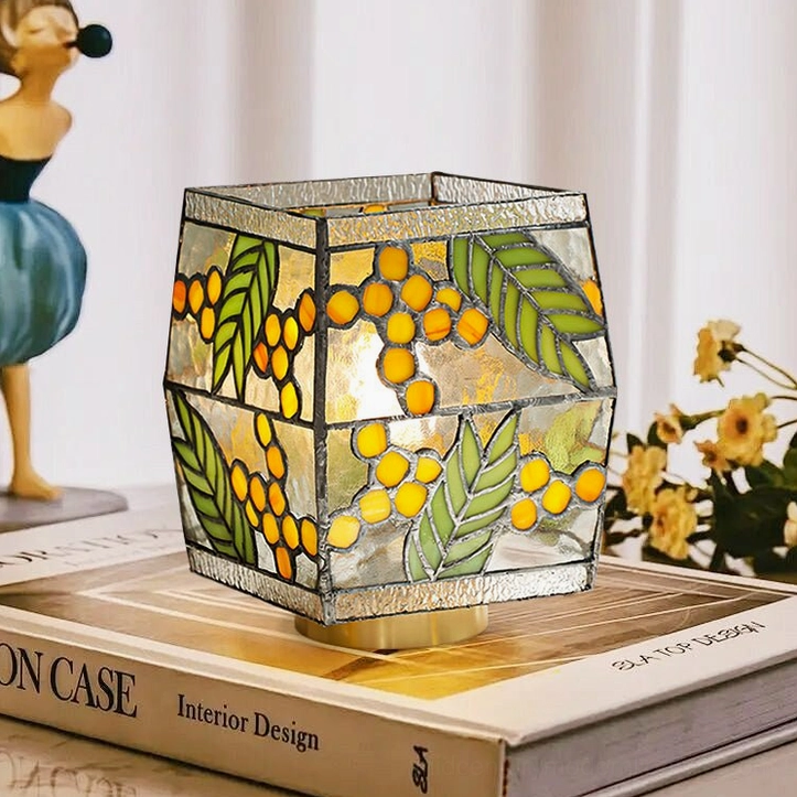 Seed Stained Glass Table Lamp on home desk with design books and cottagecore aesthetic styling