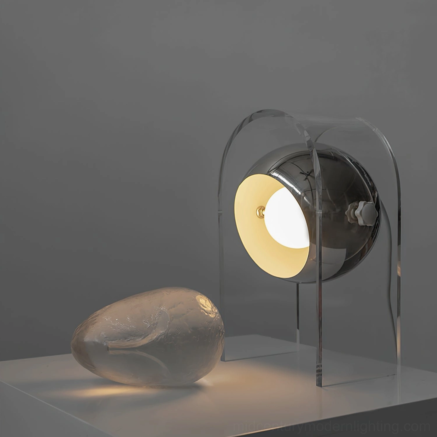 Contemporary acrylic table lamp with neutral minimalist styling and decorative accessories