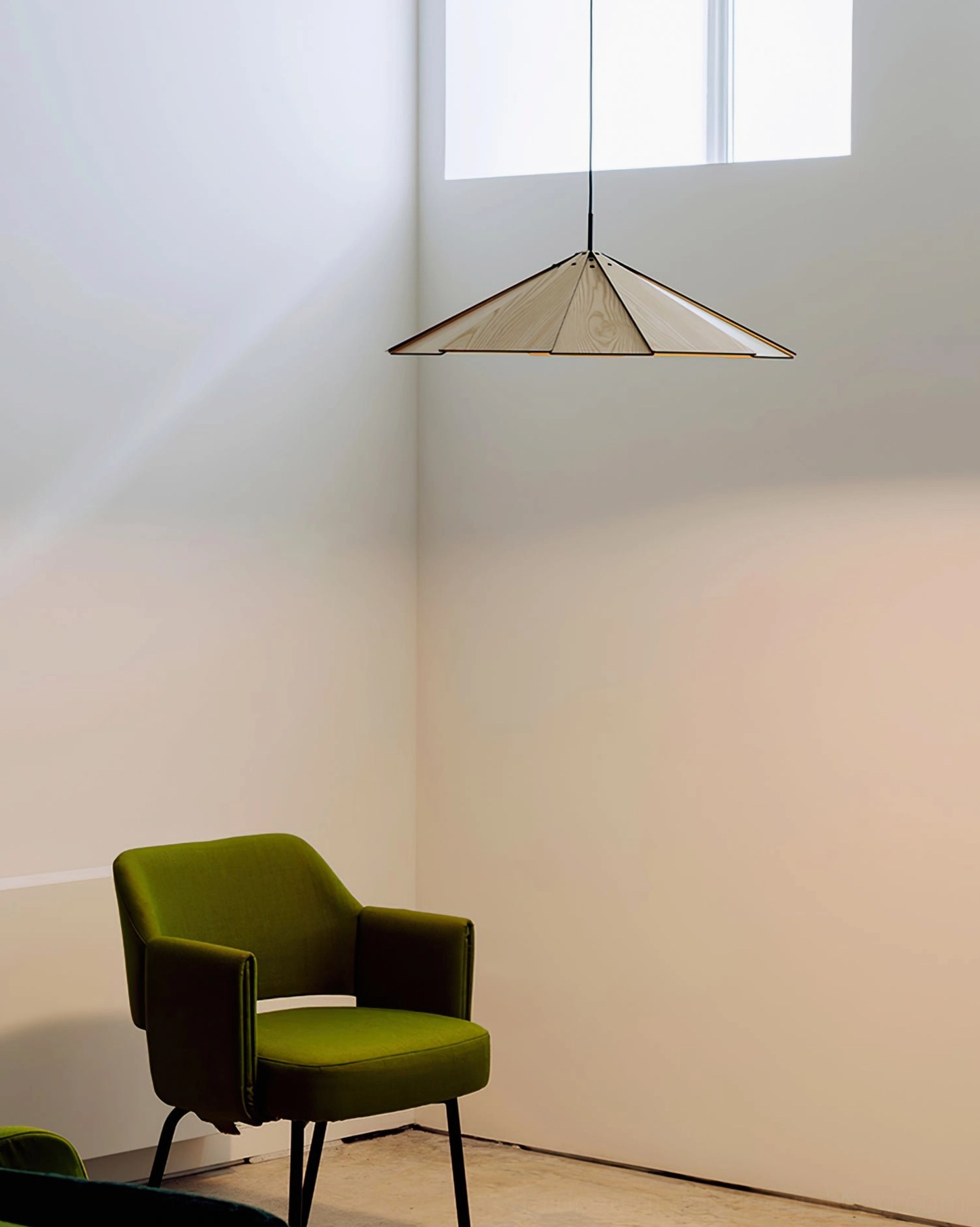 Compact sepal pendant lamp in minimalist residential corner creating modern focal point