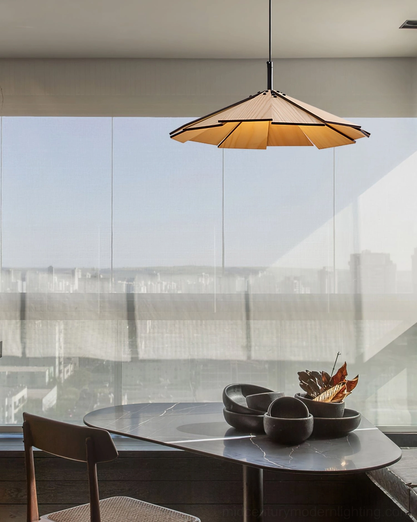 Sepal pendant lamp suspended above dining table with warm ambient glow creating intimate setting