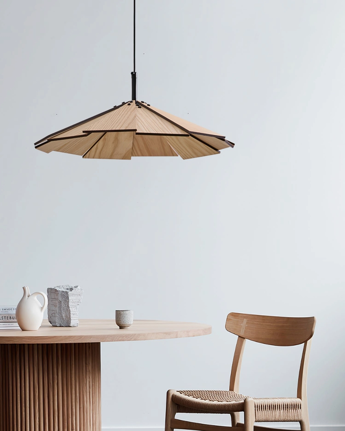 Sepal pendant lamp showing shadow patterns cast on ceiling from slatted wooden design