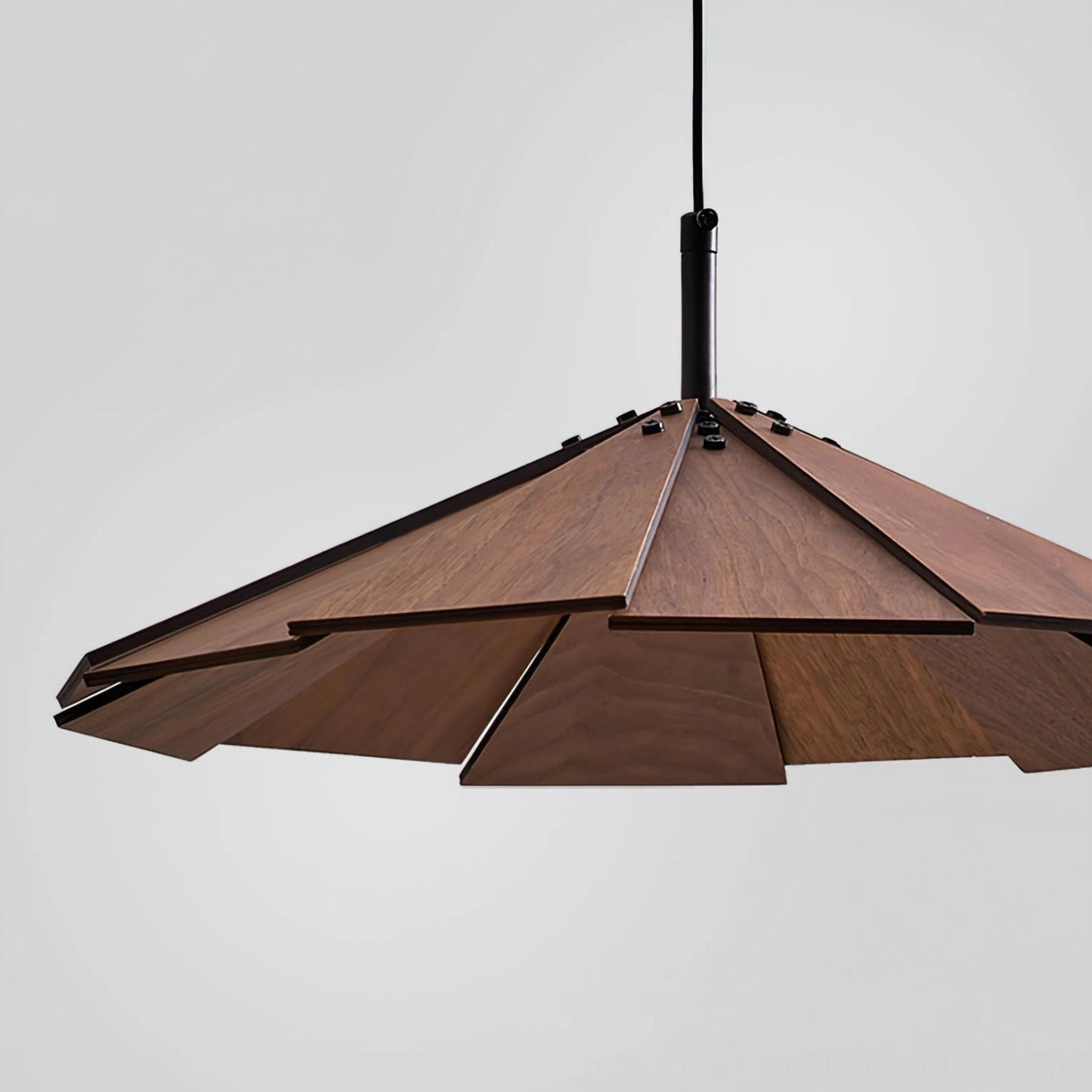 Dark walnut sepal pendant lamp side view showing angular silhouette and matte black suspension rod