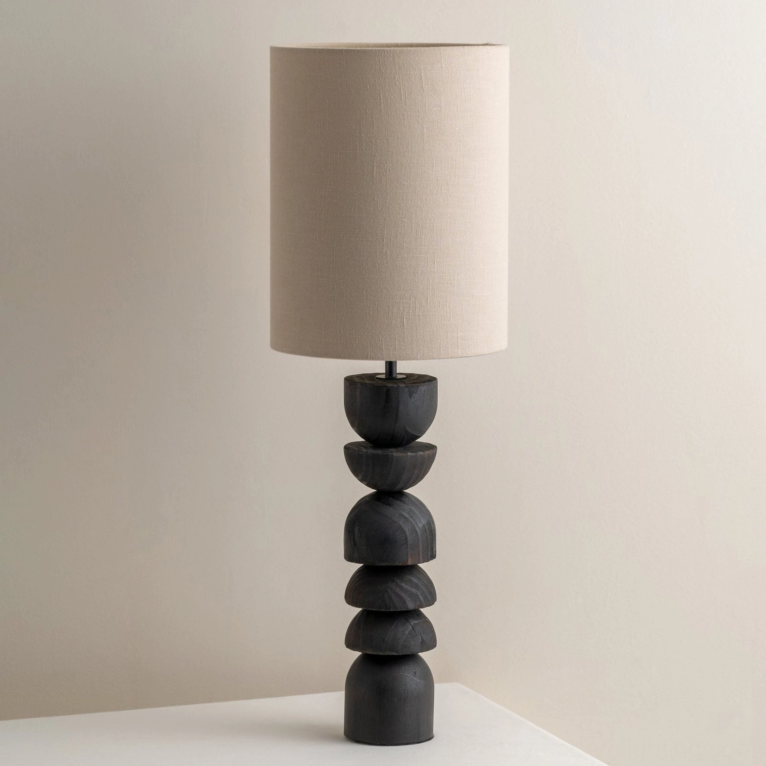 Mid-century modern Sergio table lamp three-quarter angle showing geometric stacked wood base detail