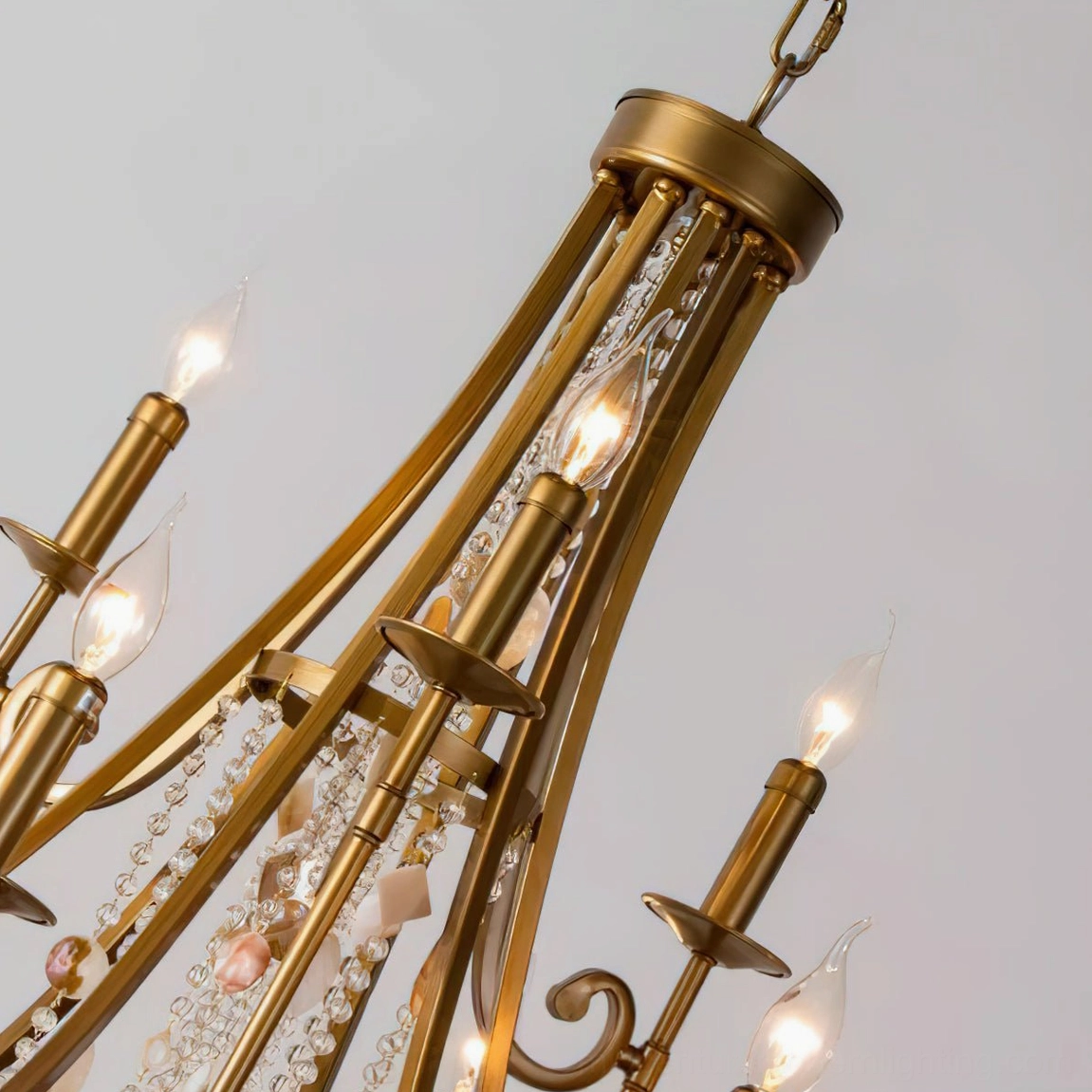 Chandelier candle bulb arm structure close-up showing exposed E14 sockets and brass metal construction