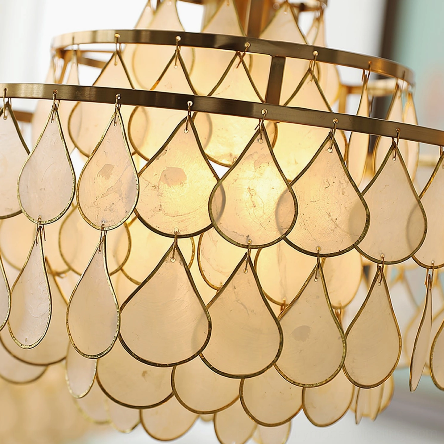 Shell pendant lamp mounted on ceiling in modern living room, demonstrating proper installation and ambient lighting effect in contemporary interior