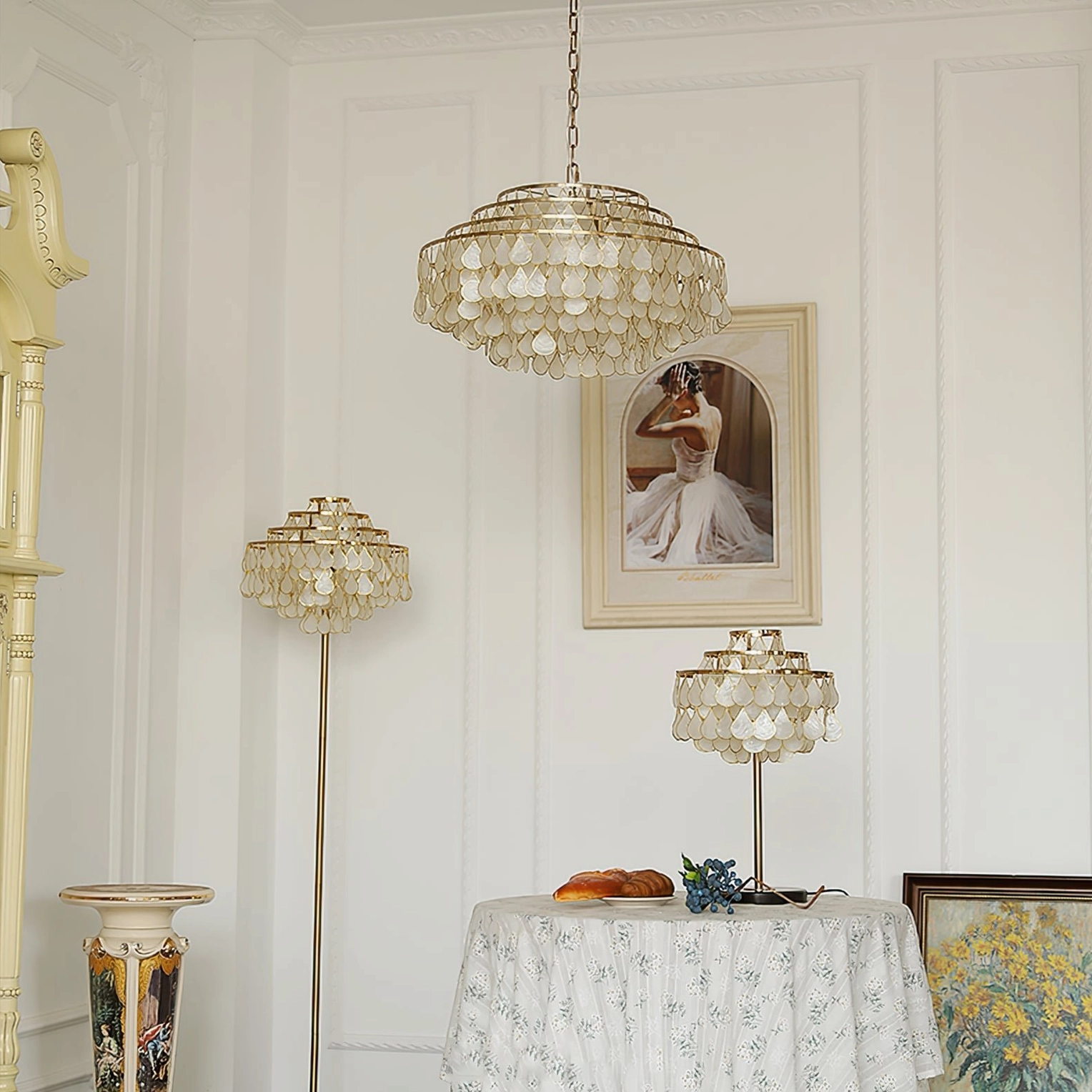 White shell pendant lamp with gold frame and chain, detail view showing layered teardrop shell construction and metal framework