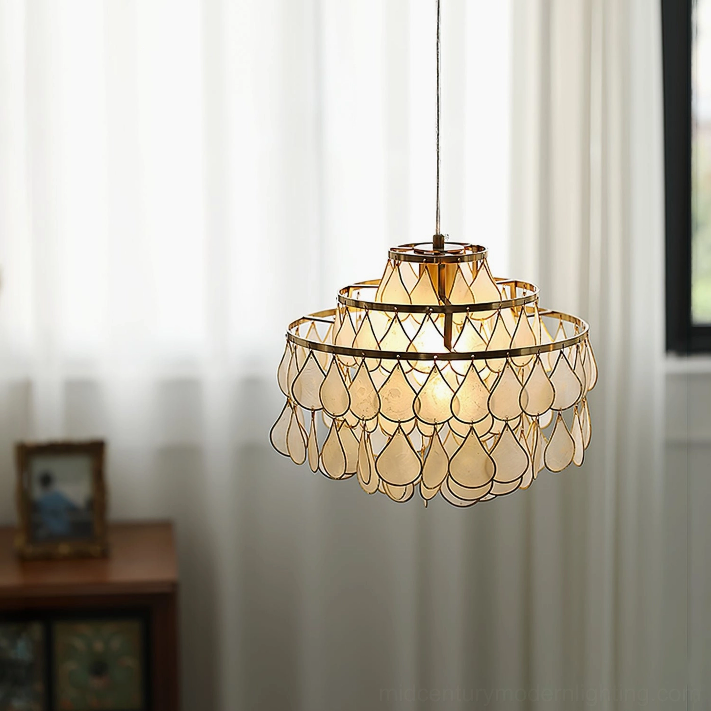 Tiered shell pendant lamp showcasing organic beauty and sculptural form, natural light interaction with genuine shell material