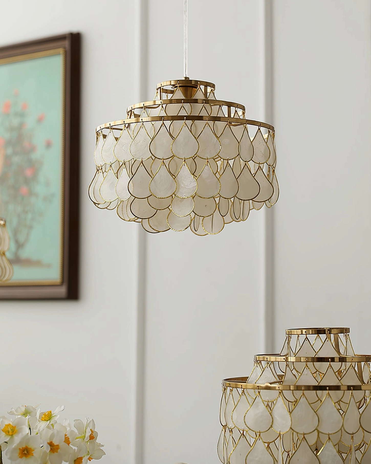 Elegant tiered shell pendant lamp in scandinavian minimalist home setting, showcasing clean lines and organic materials aesthetic