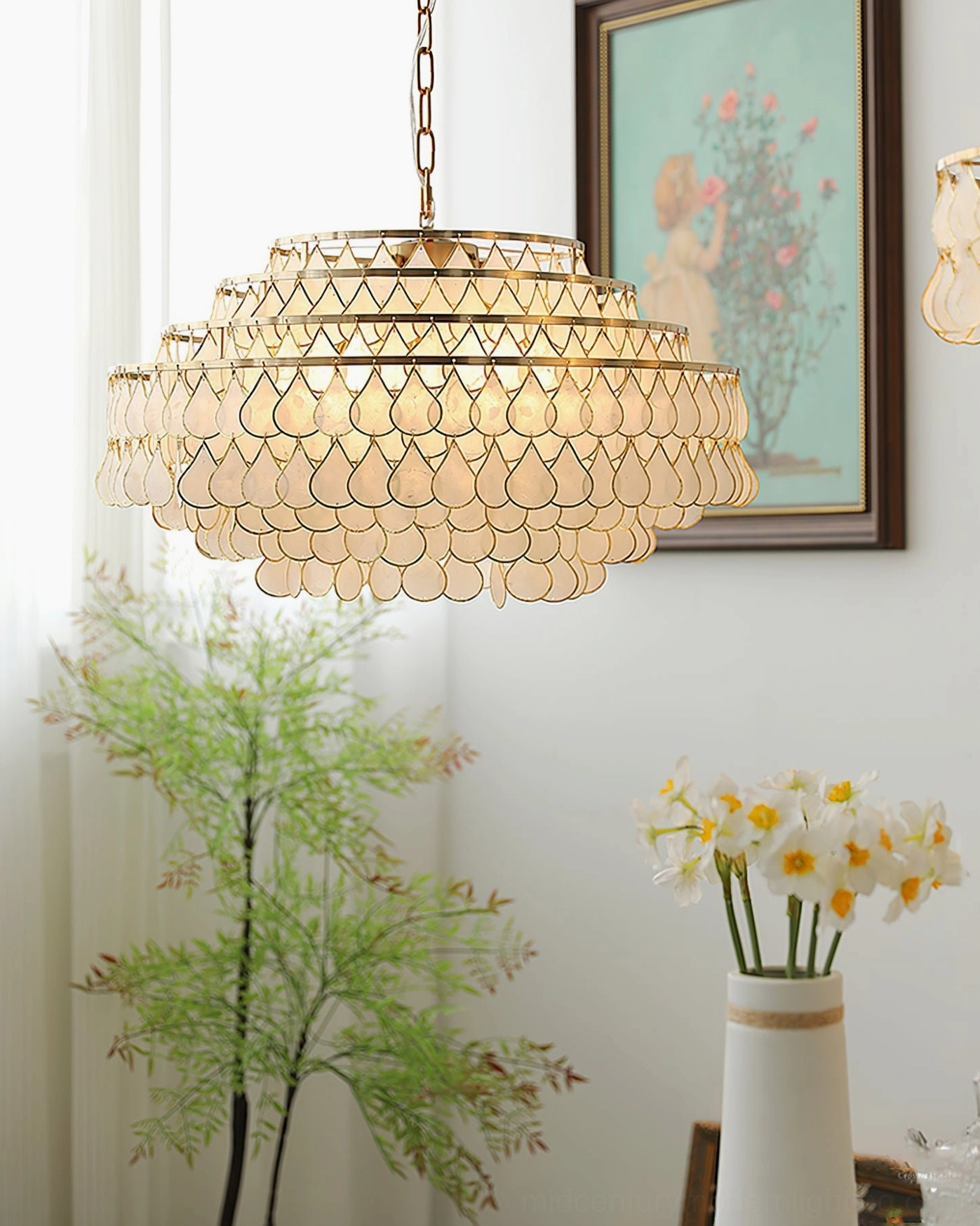 Tiered shell pendant lamp three-quarter side view, bright indoor space with wall art, potted plant and floral decor, light luxury retro design