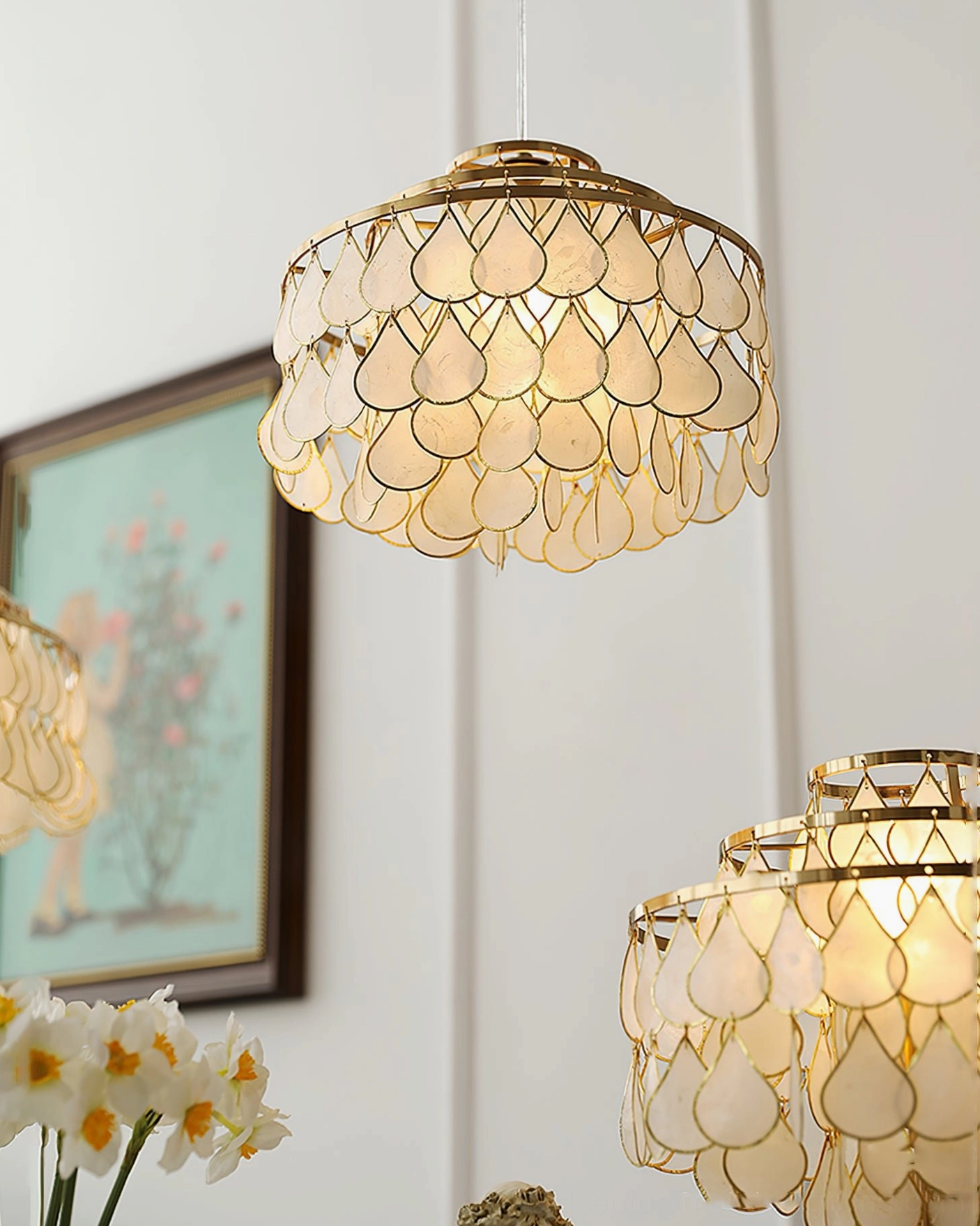 Multiple shell pendant lamps in graduated sizes showing product range, from small to large, displayed together for size comparison